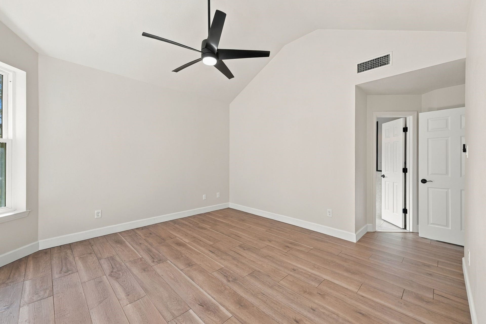 1065 Heritage Lane, Conroe, TX 77304 View of primary bedroom showing the doors to the hallway and to the ensuite bath.