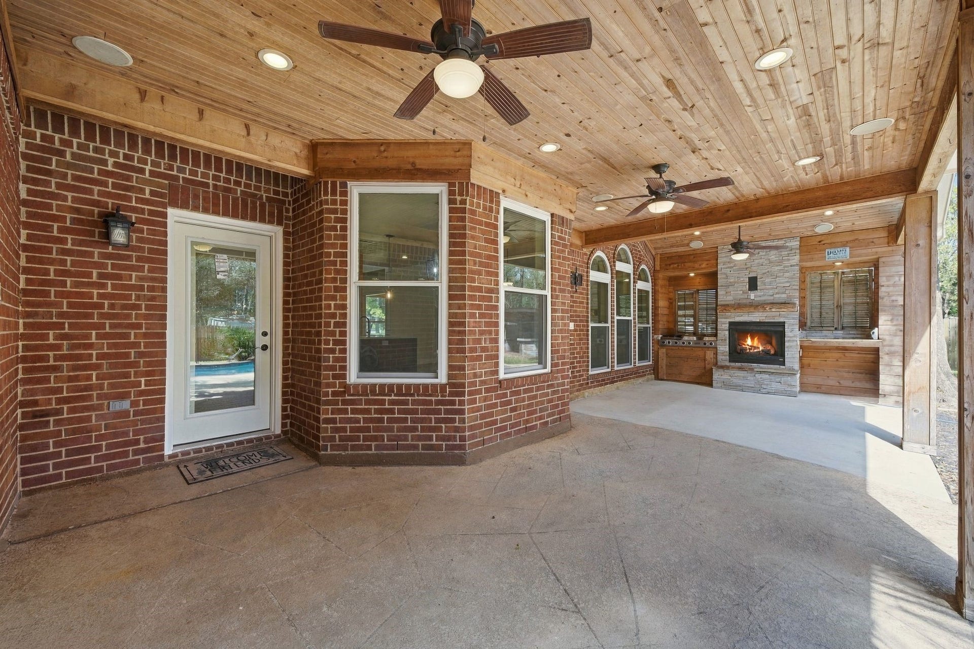 1065 Heritage Lane, Conroe, TX 77304 Swoon worthy!!! This will be your favorite spot! Friends, games, parties, cookouts! This is the place! Look at that custom wood paneled ceiling! The updated lighting, the outdoor kitchen, the fire place!!