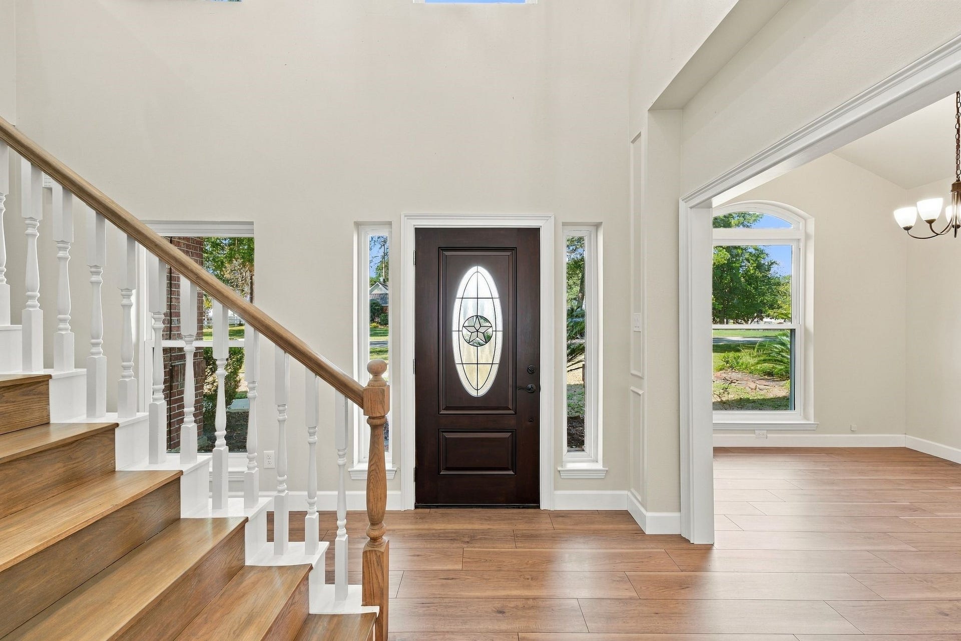 1065 Heritage Lane, Conroe, TX 77304 The entry way leads to a home office (to the right in this picture) and to the staircase. Notice the gorgeous Laminate wood look floors and fresh neutral paint!