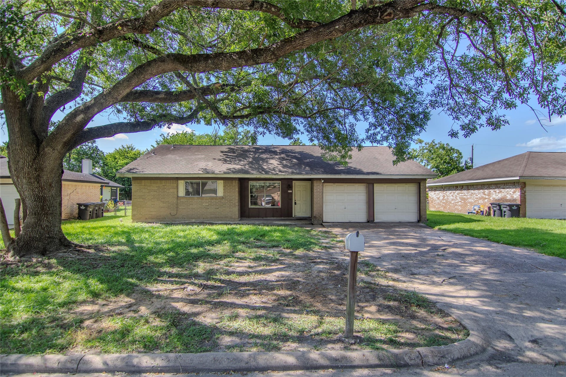 front of house with mature tree and porch