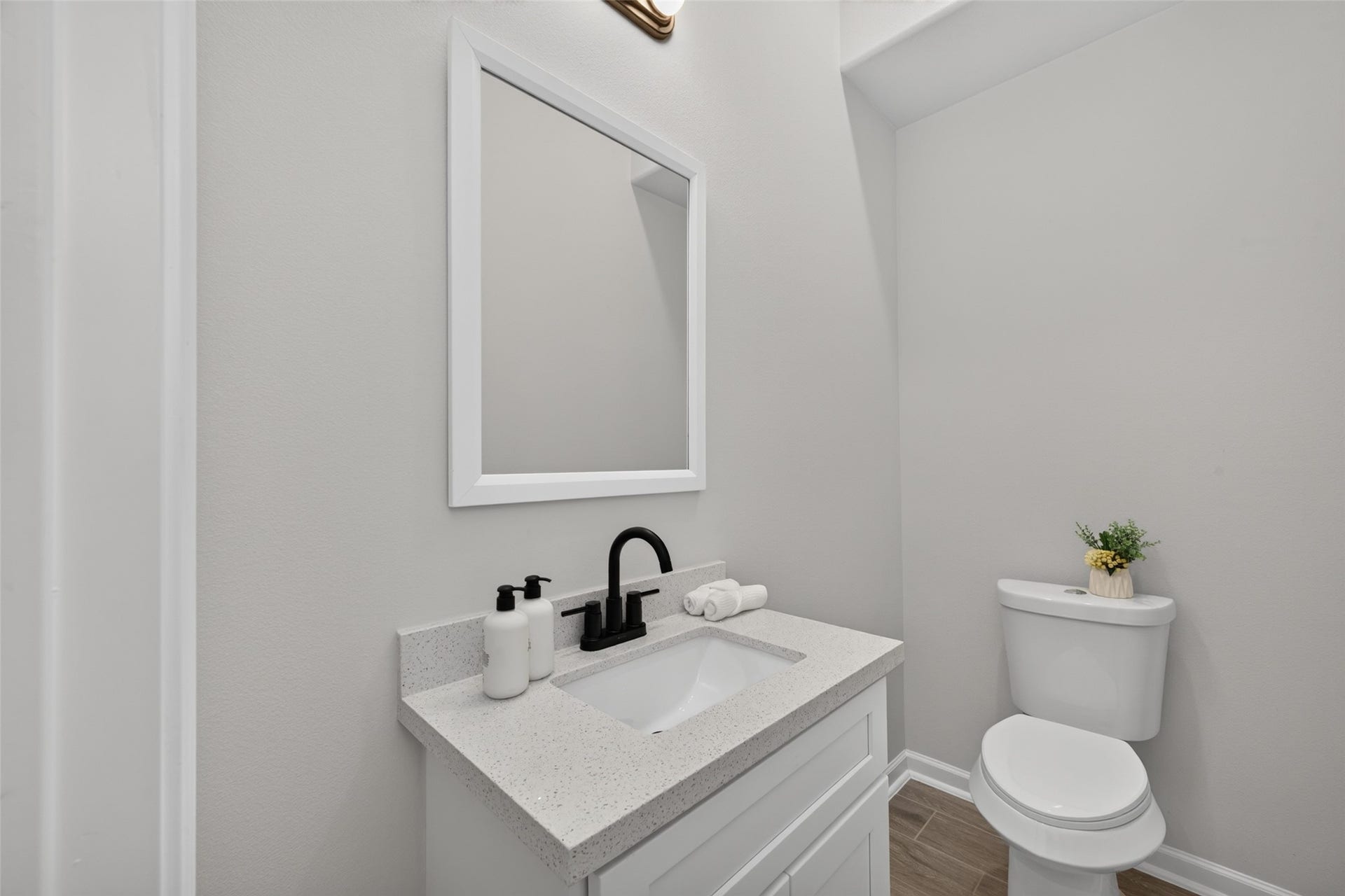 5915 Haight Street, #A, Houston, TX 77028 First-floor powder room featuring an upgraded vanity and an elegant high-arc faucet.