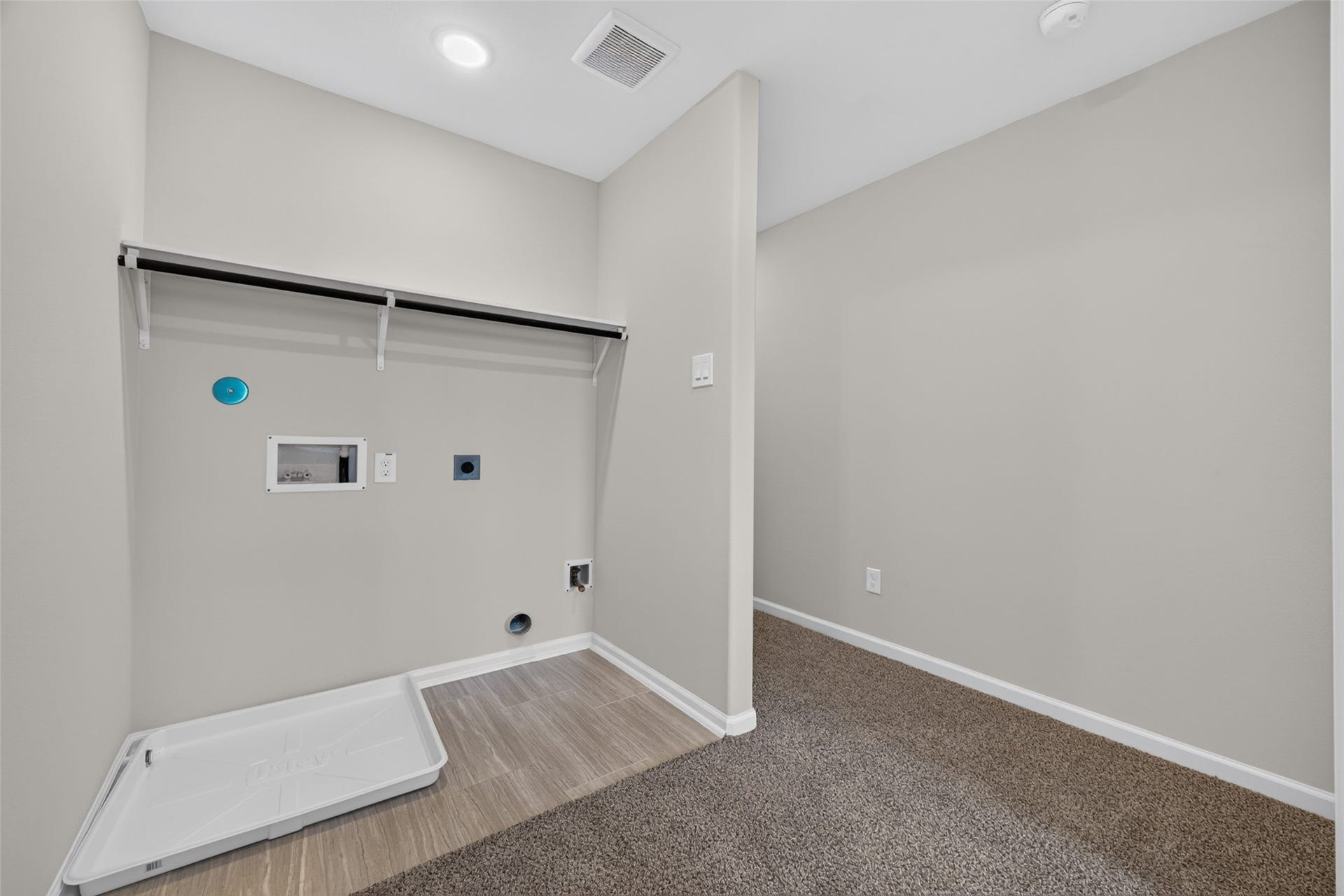 5915 Haight Street, #A, Houston, TX 77028 Spacious laundry room with modern hookups, ample shelving, and a combination of carpet and tile flooring for functionality.