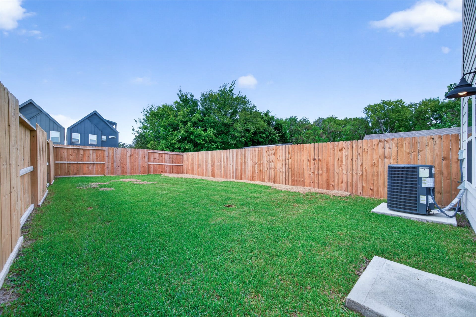 5915 Haight Street, #A, Houston, TX 77028 Expansive fenced backyard with lush green lawn, perfect for outdoor activities and privacy.