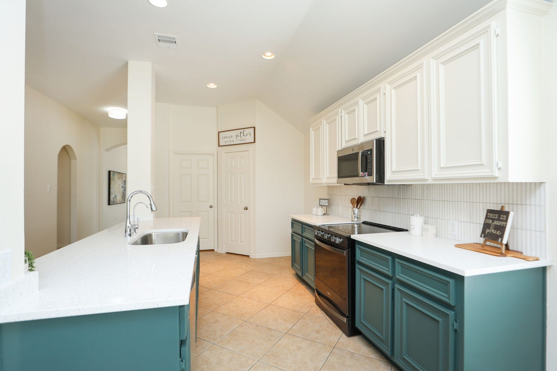 4814 Mosaic Canyon Court, Humble, TX 77396 Room for bar stools at this large island for friends and family to gather around. Pantry and laundry room in back of photo with hallway to secondary bedrooms on the left of this photo. Split floorplan is very peaceful and gives privacy to the primary suite in the rear.