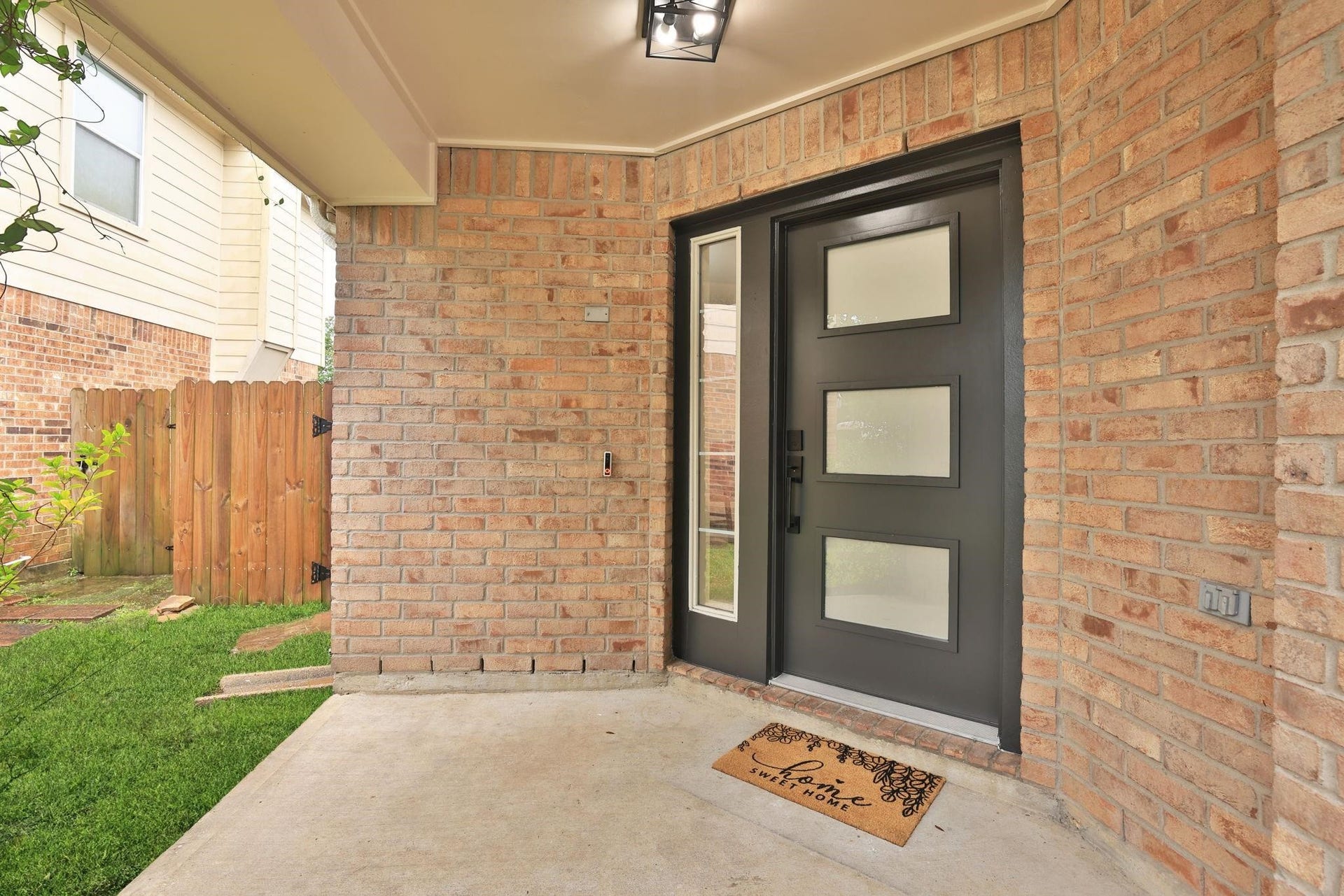 4814 Mosaic Canyon Court, Humble, TX 77396 A close-up look at the modern frosted glass panel front door and a ring doorbell. Exterior also has new light fixtures.