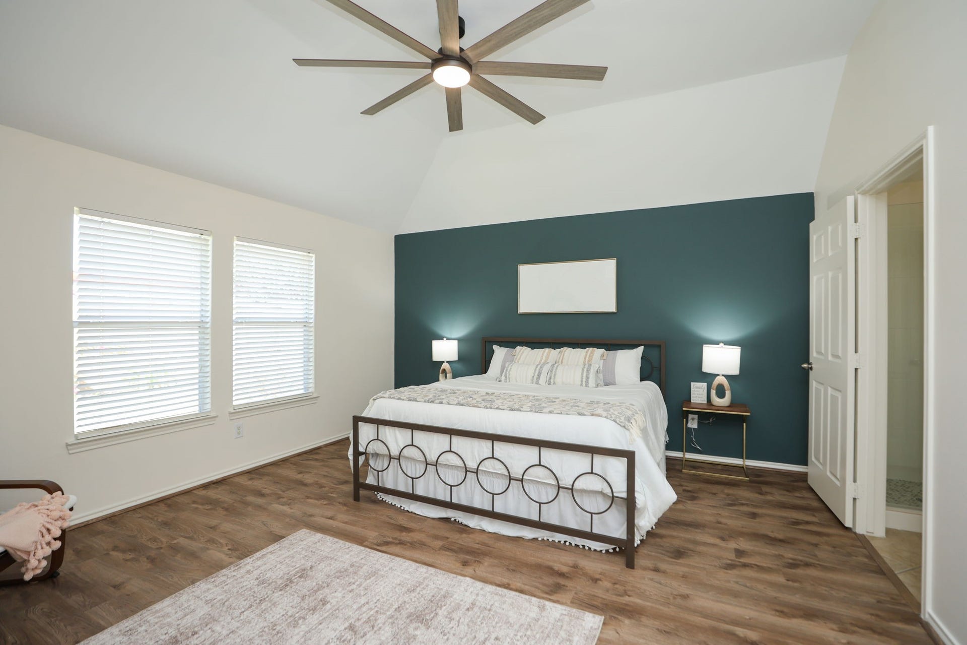 4814 Mosaic Canyon Court, Humble, TX 77396 Peaceful primary suite in the rear of the home, also featuring an 8 blade fan, Hidden Gem accent wall, and modern LVP flooring. Primary bath is to the right of this photo.