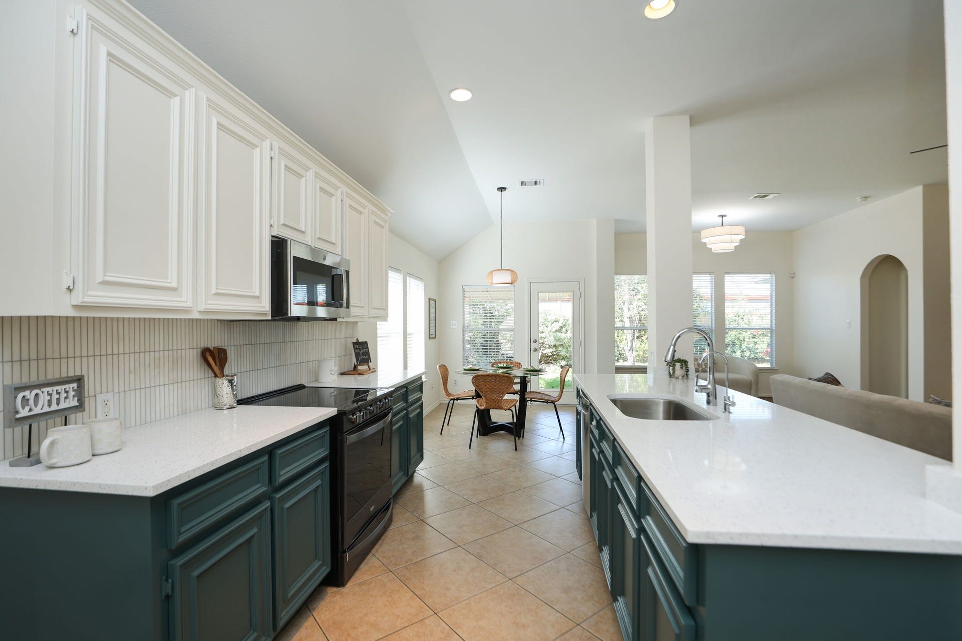 4814 Mosaic Canyon Court, Humble, TX 77396 Kitchen features duo-toned cabinets, new countertops and vertical channel set backsplash!