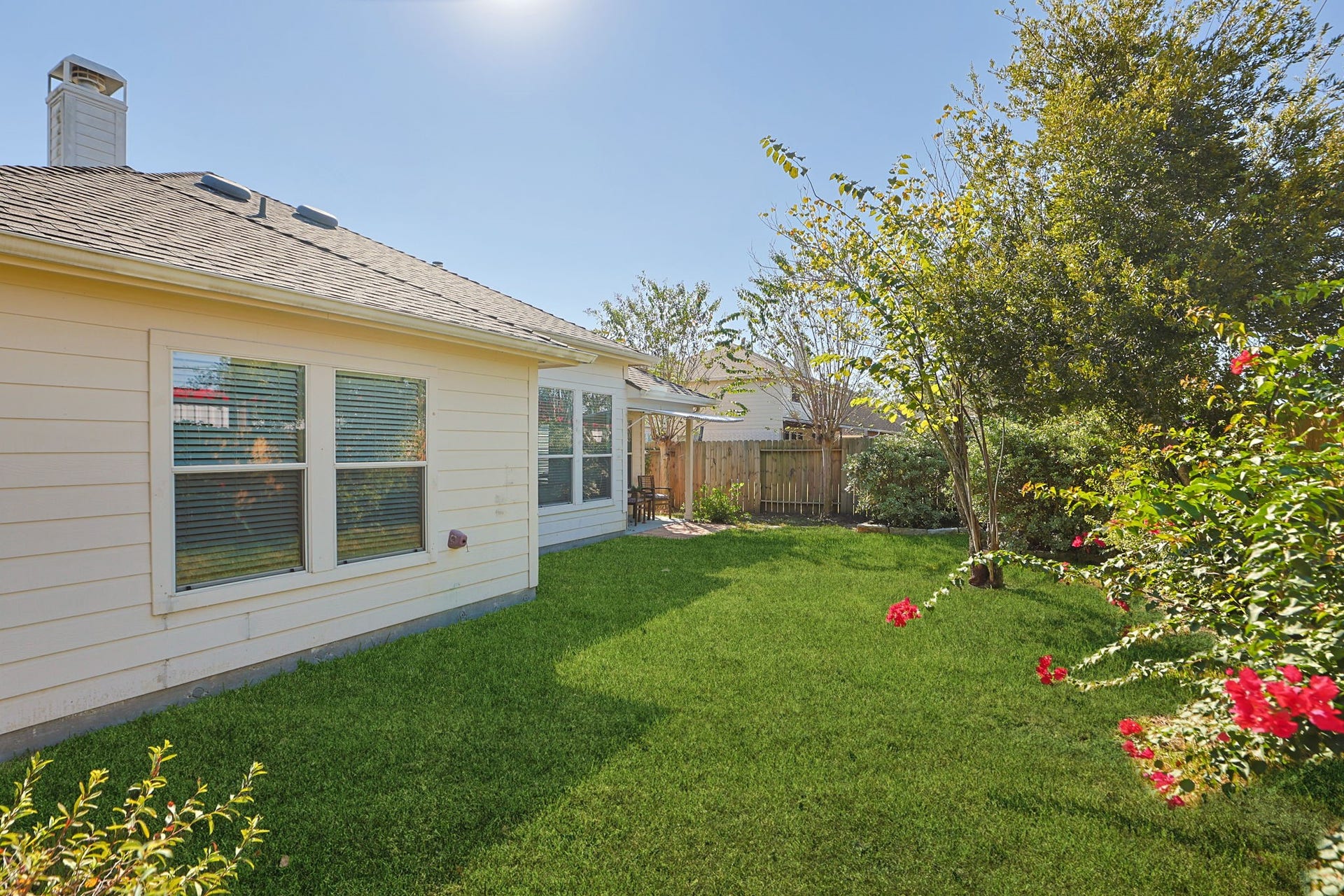 4814 Mosaic Canyon Court, Humble, TX 77396 Lush landscaped back yard with grass, plants, and room to play.