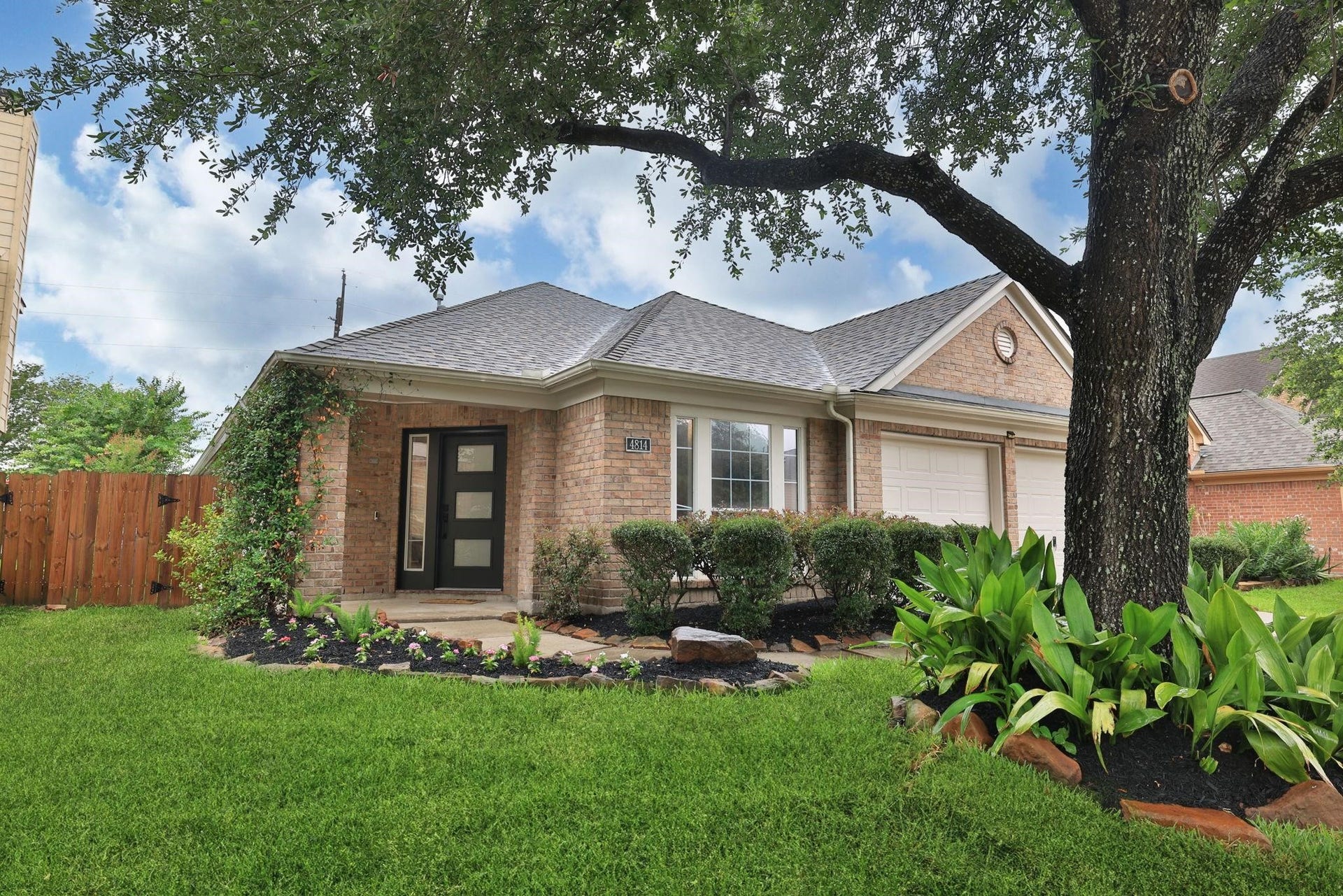4814 Mosaic Canyon Court, Humble, TX 77396 Fabulously landscaped yard with a neighborhood live oak out front.