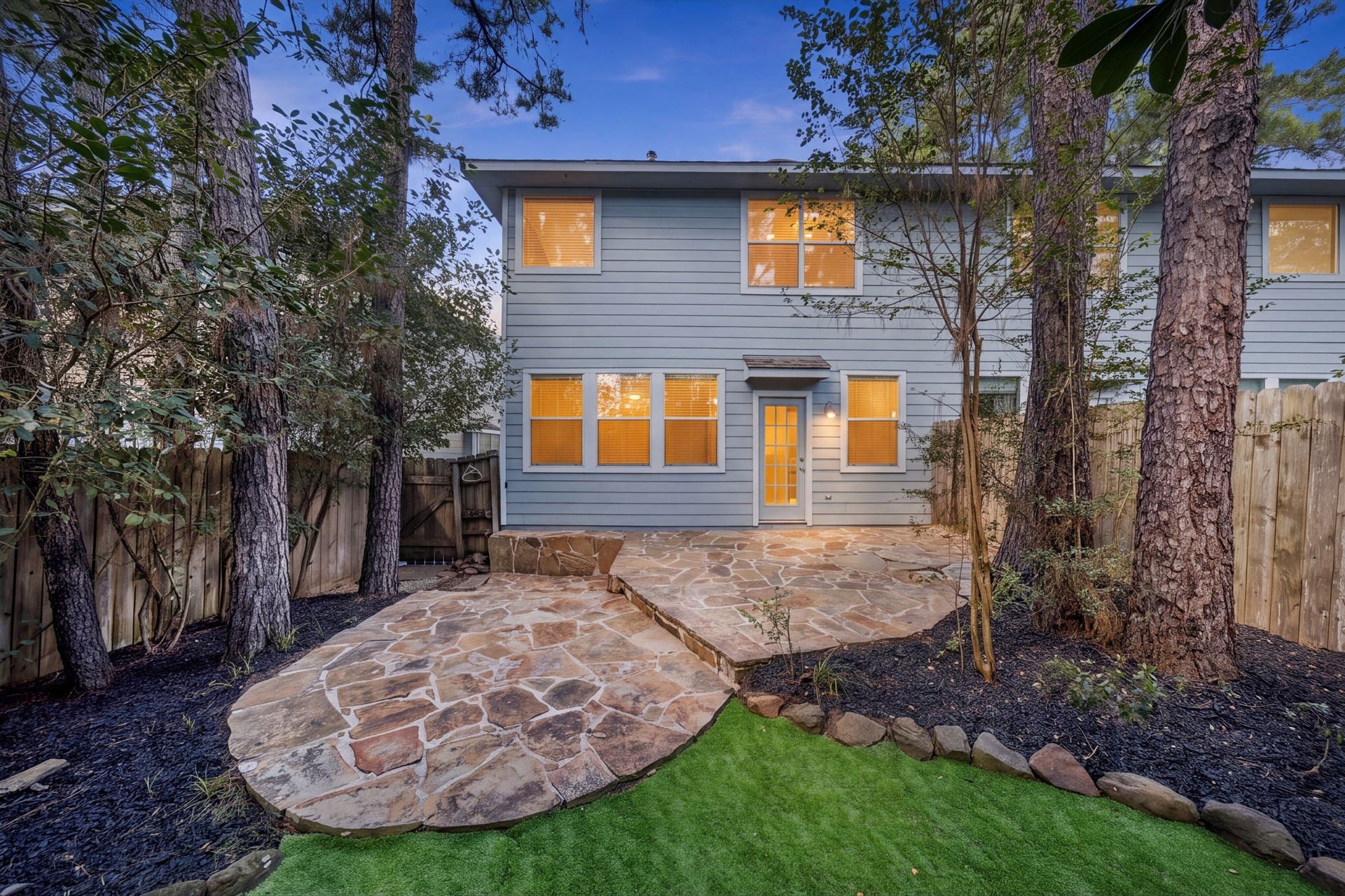 30 Blue Creek Place, The Woodlands, TX 77382 Overhauled back yard with hard to find entertaining space! Elevated stone patio areas and brand new turf! No maintenance landscaping!
