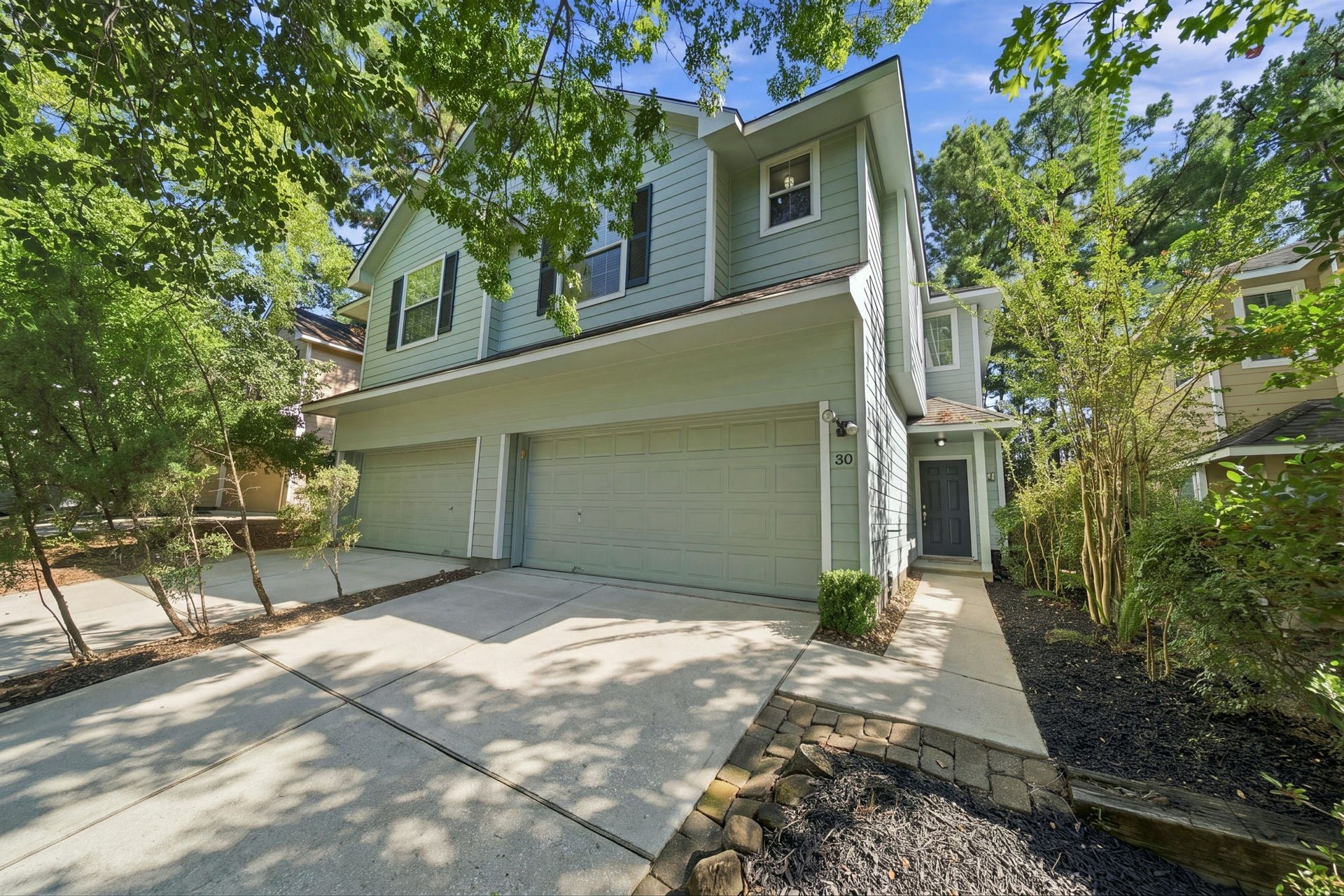 30 Blue Creek Place, The Woodlands, TX 77382 Nice curb appeal with mature privacy landscaping.