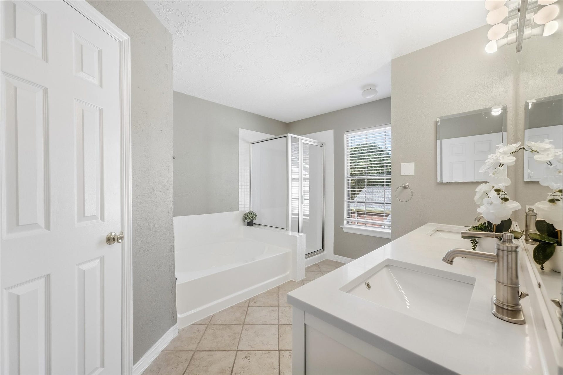 1926 Victoria Garden Drive, Richmond, TX 77406 Spa-like primary bath with soaking tub, dual sinks, and walk-in shower