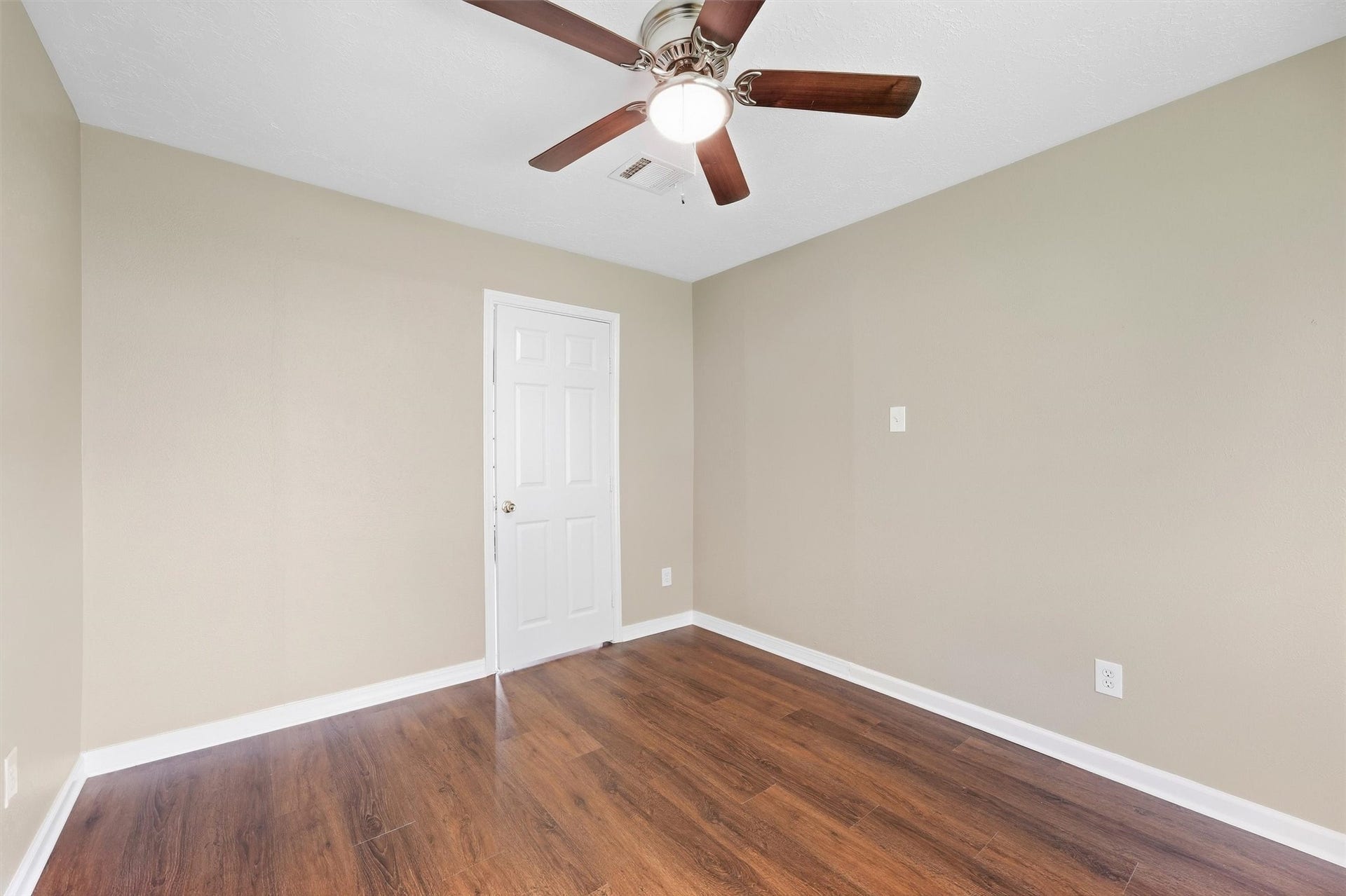 1926 Victoria Garden Drive, Richmond, TX 77406 Grand primary bedroom featuring elegant flooring and abundant light offering a peaceful retreat