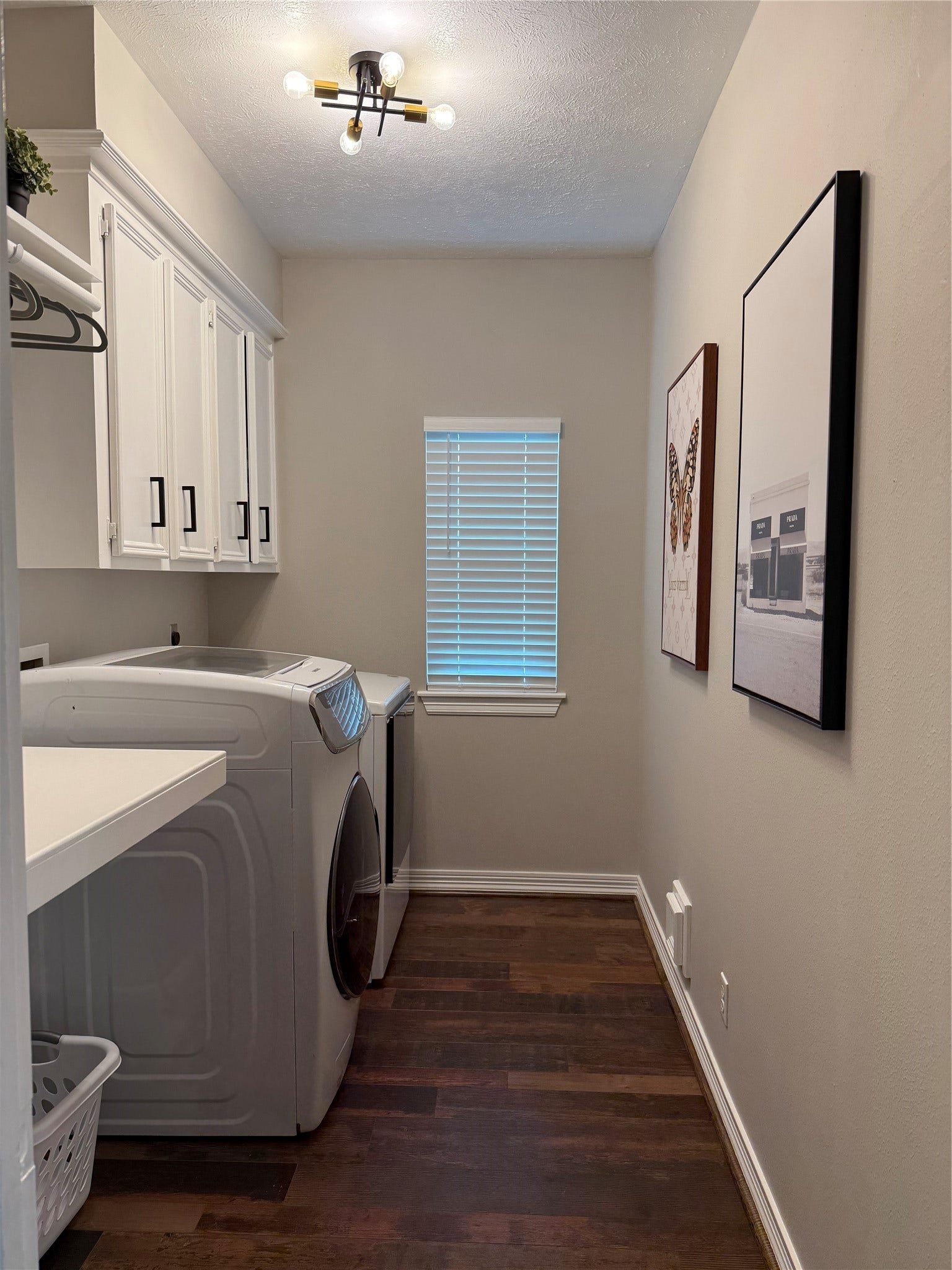 Laundry room with additional storage Cabinets above