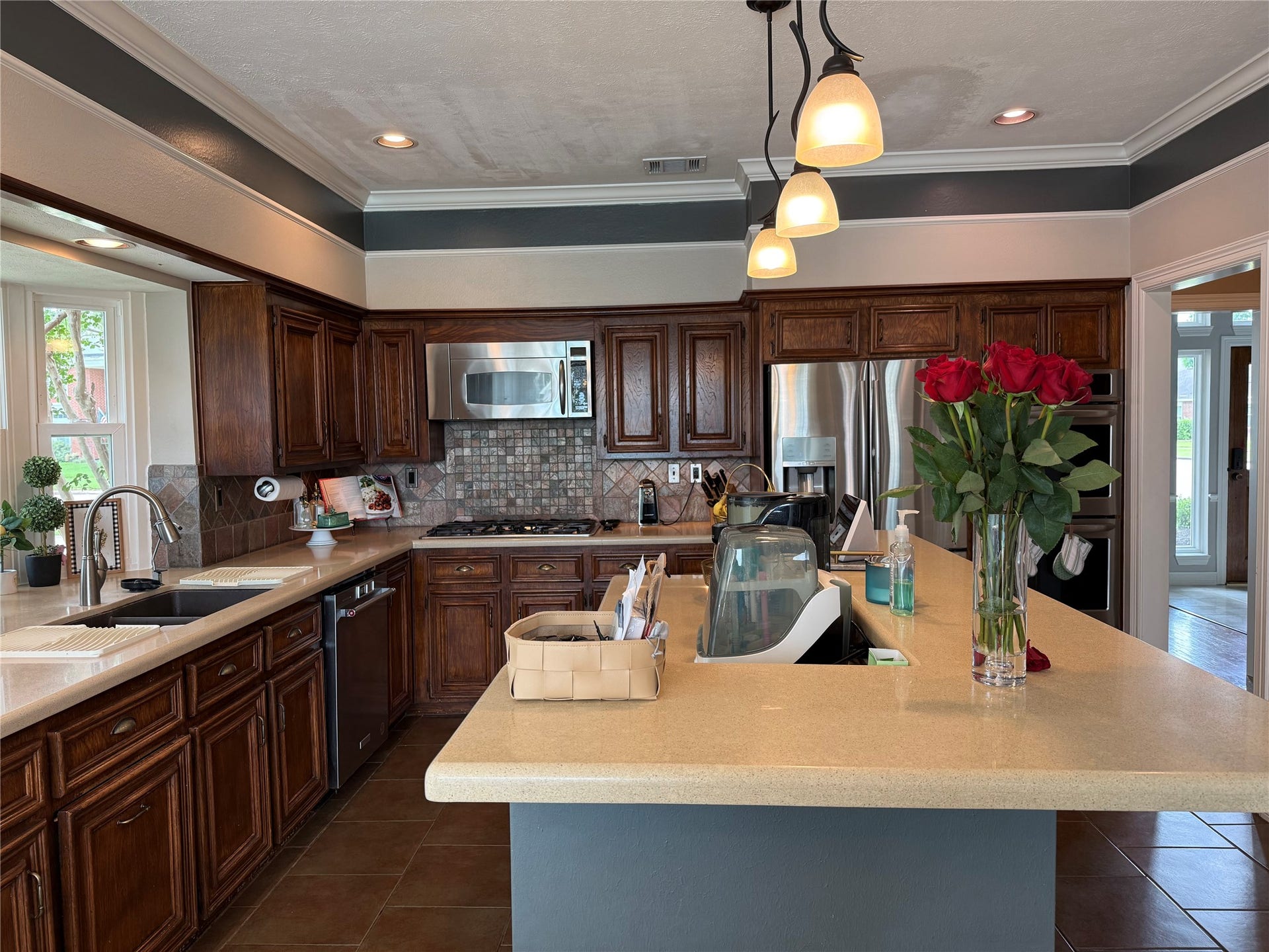A beautifully designed kitchen island with ample storage and drawers enhances both style and functionality in this inviting space.