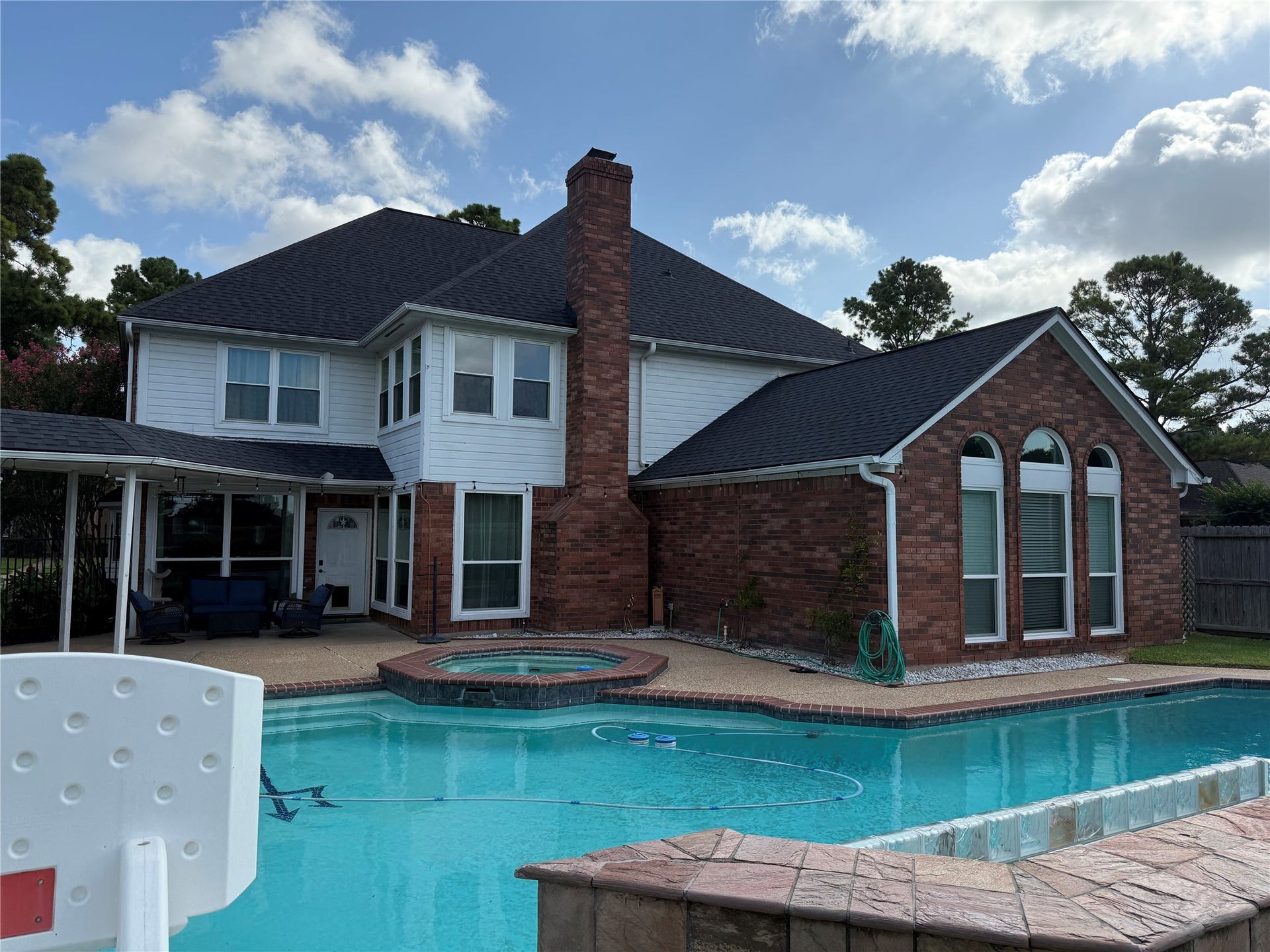 Oversized swimming pool with attached hot tub