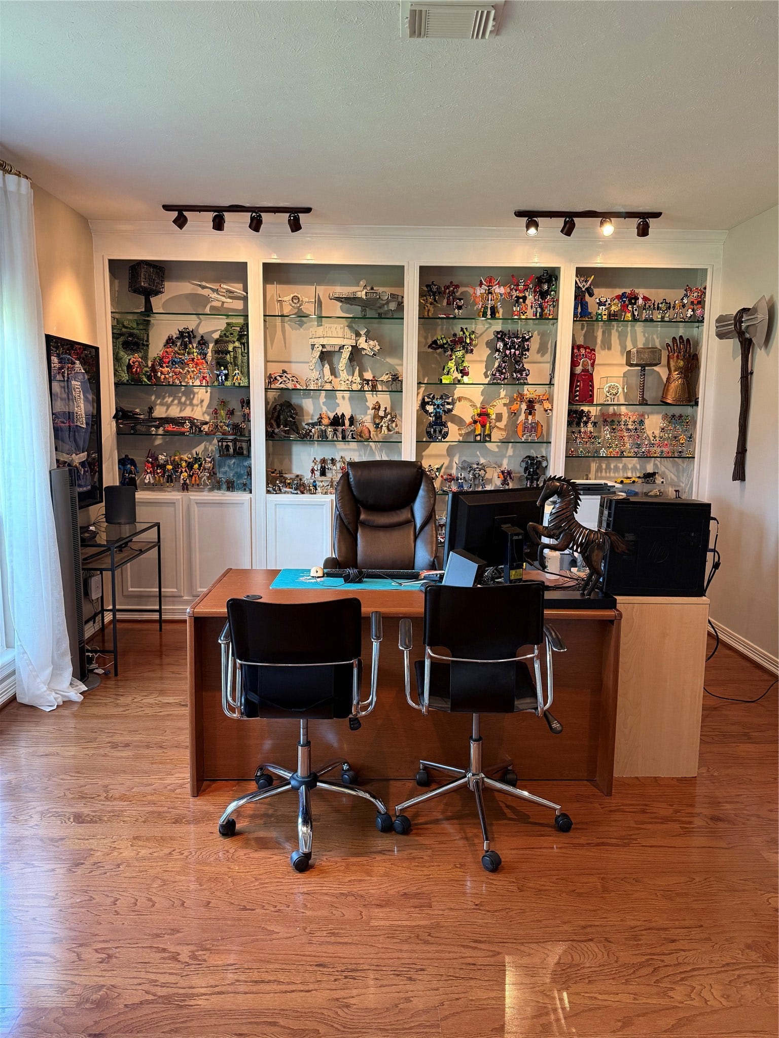 Elevate your productivity in a sophisticated home office featuring custom built-ins, seamlessly connecting to elegant living spaces.