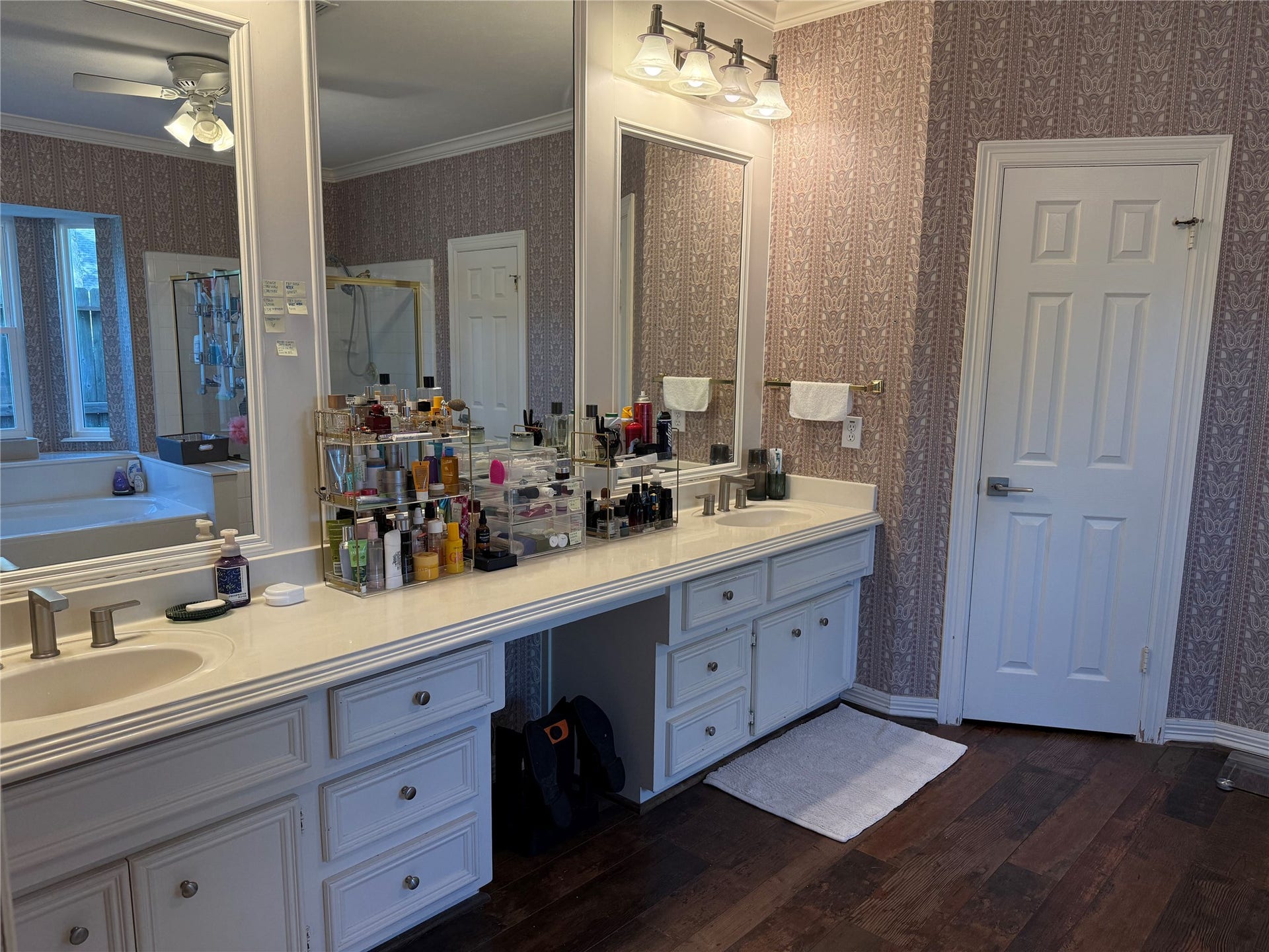 Experience luxury in the primary bath featuring elegant double sinks, a spacious vanity area, and a discreet water closet.