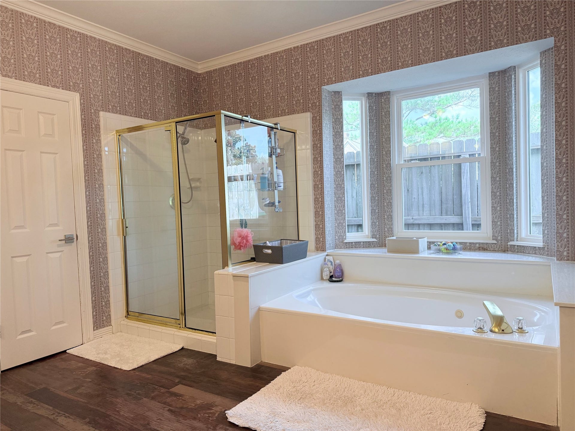Indulge in the serene luxury of a primary bath featuring an oversized garden tub and a separate shower for an ultimate spa-like retreat at home.