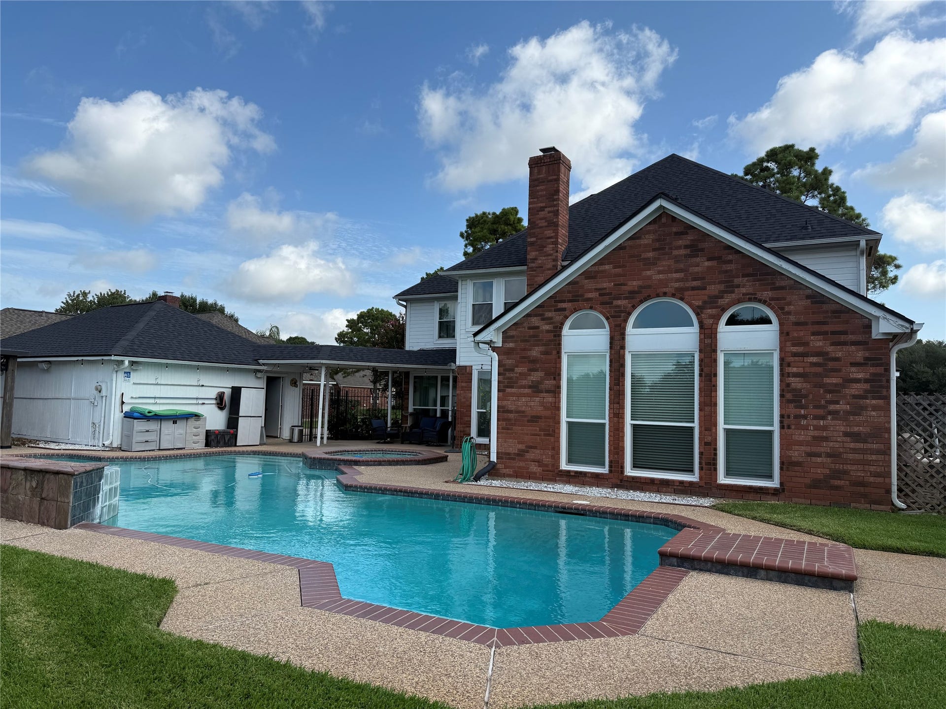 Oversized swimming pool with attached hot tub