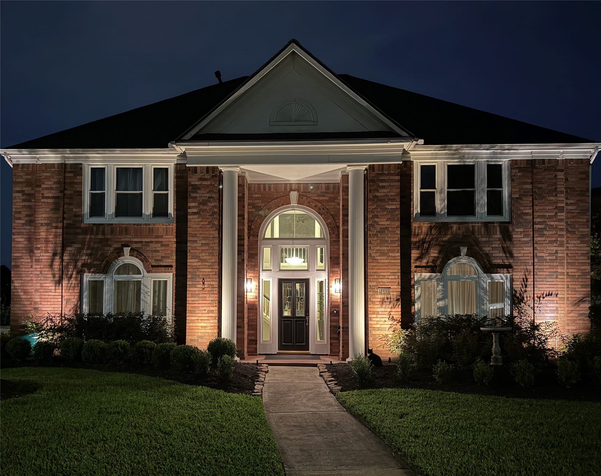 A stunning two-story home graces an expansive corner lot, offering elegance and ample space for living and entertaining.