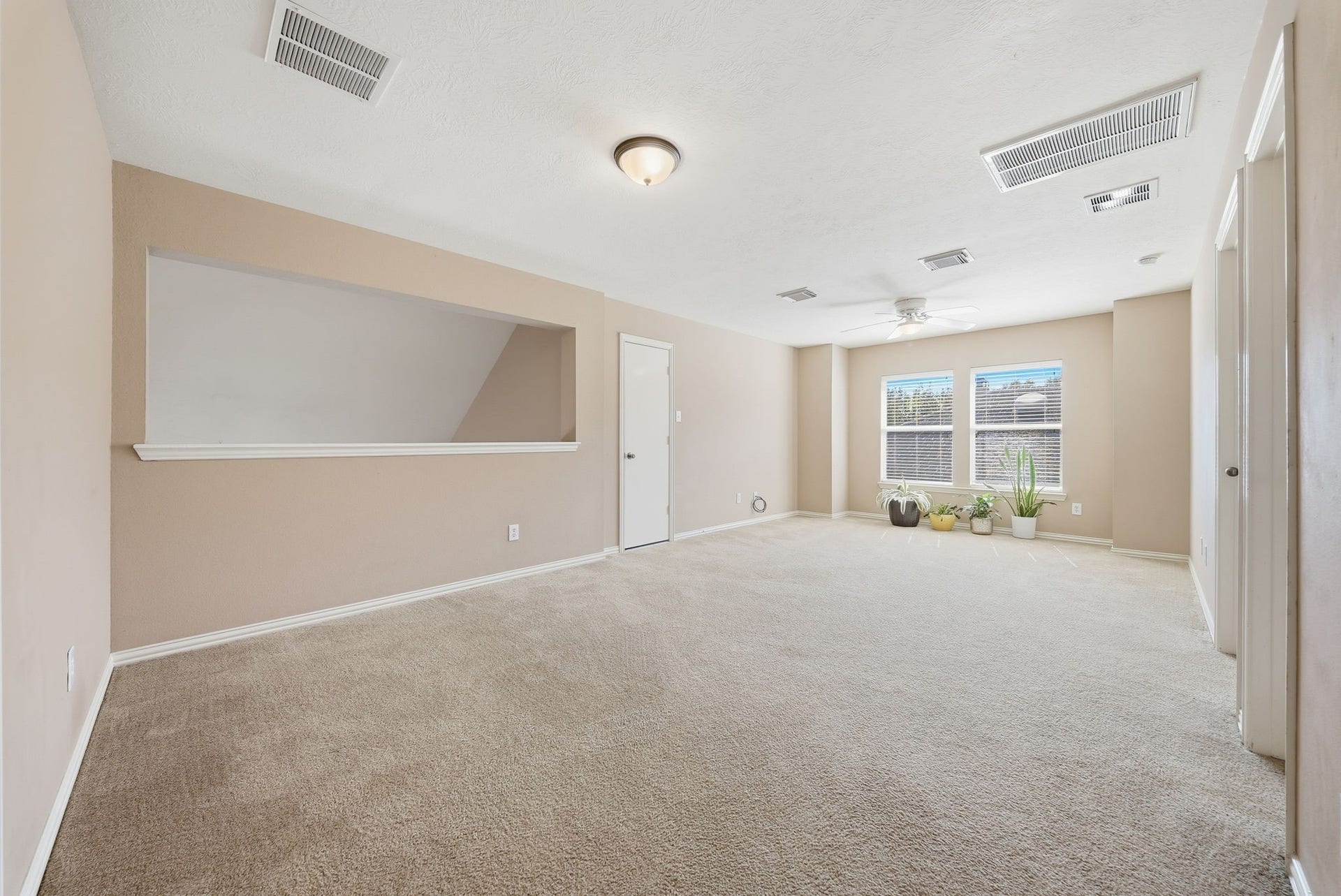 Upstairs game room serves as a central gathering space with direct access to all three secondary bedrooms and a full bathroom, keeping comfort and convenience close by.