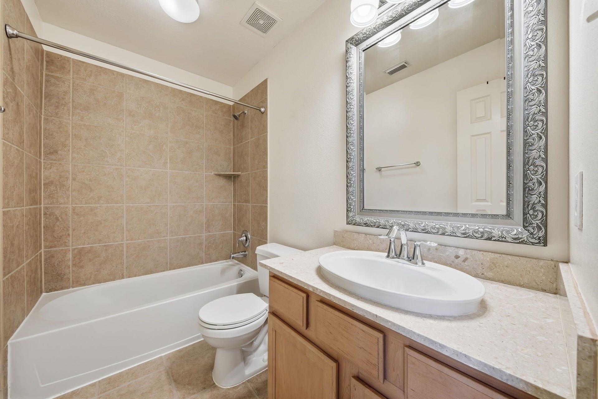 Full bathroom just off the upstairs game room offers convenient access for all three secondary bedrooms and guests enjoying the additional living space.