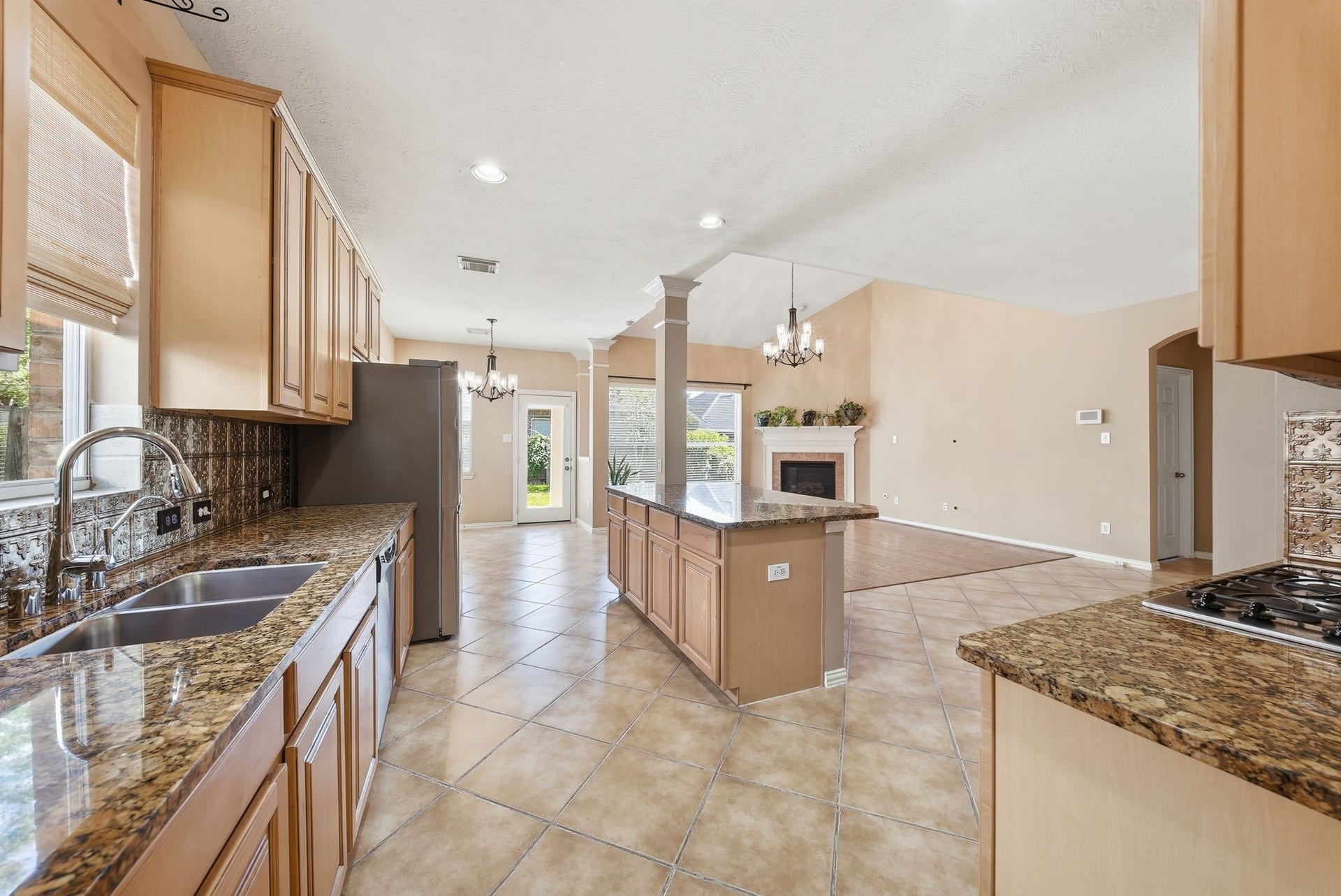 High ceilings and an open layout connect the kitchen, breakfast area, and living room, making everyday meals and entertaining feel effortless.