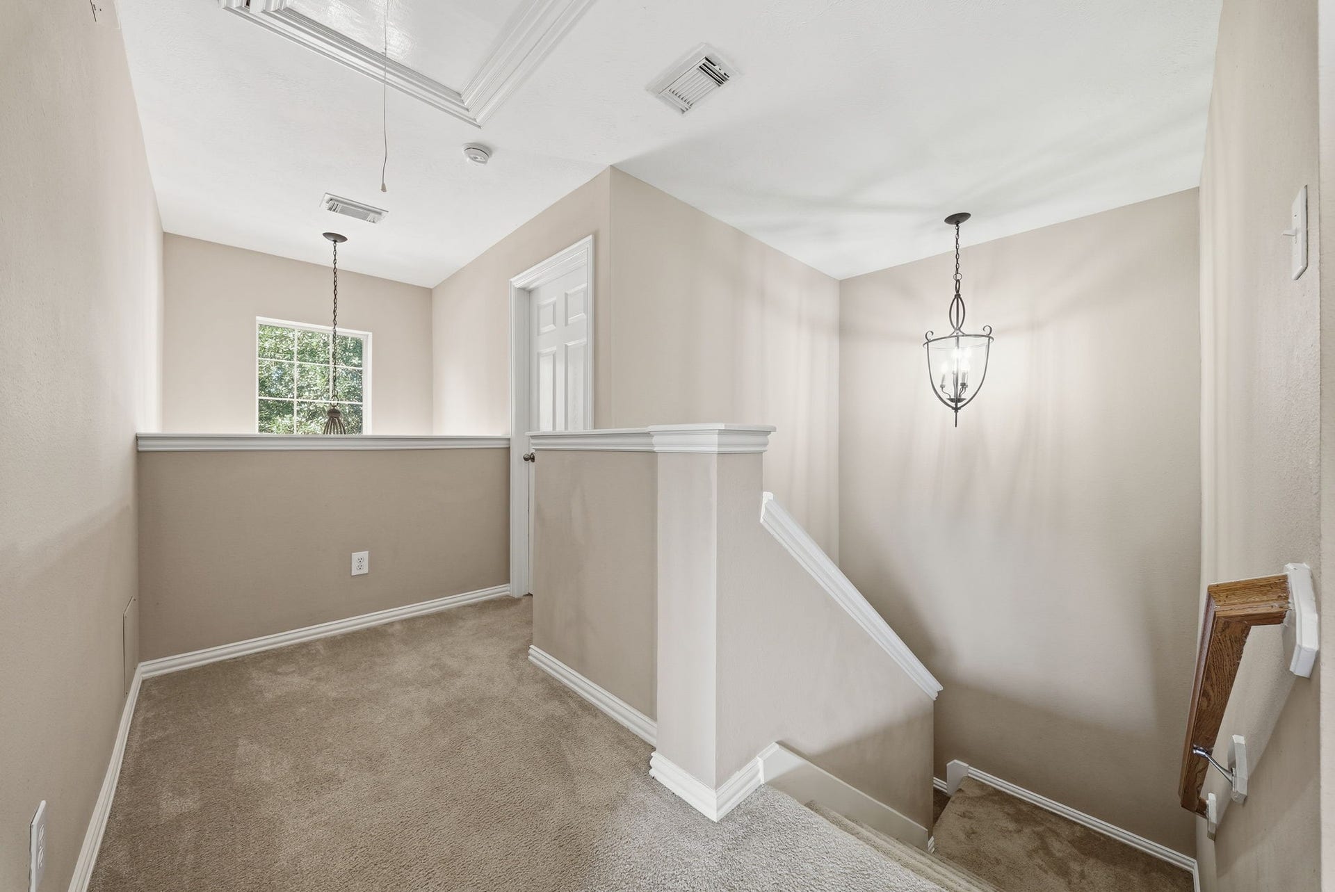 Upstairs landing opens to the game room, with secondary bedrooms to the left and right, creating a convenient layout for relaxation and recreation.