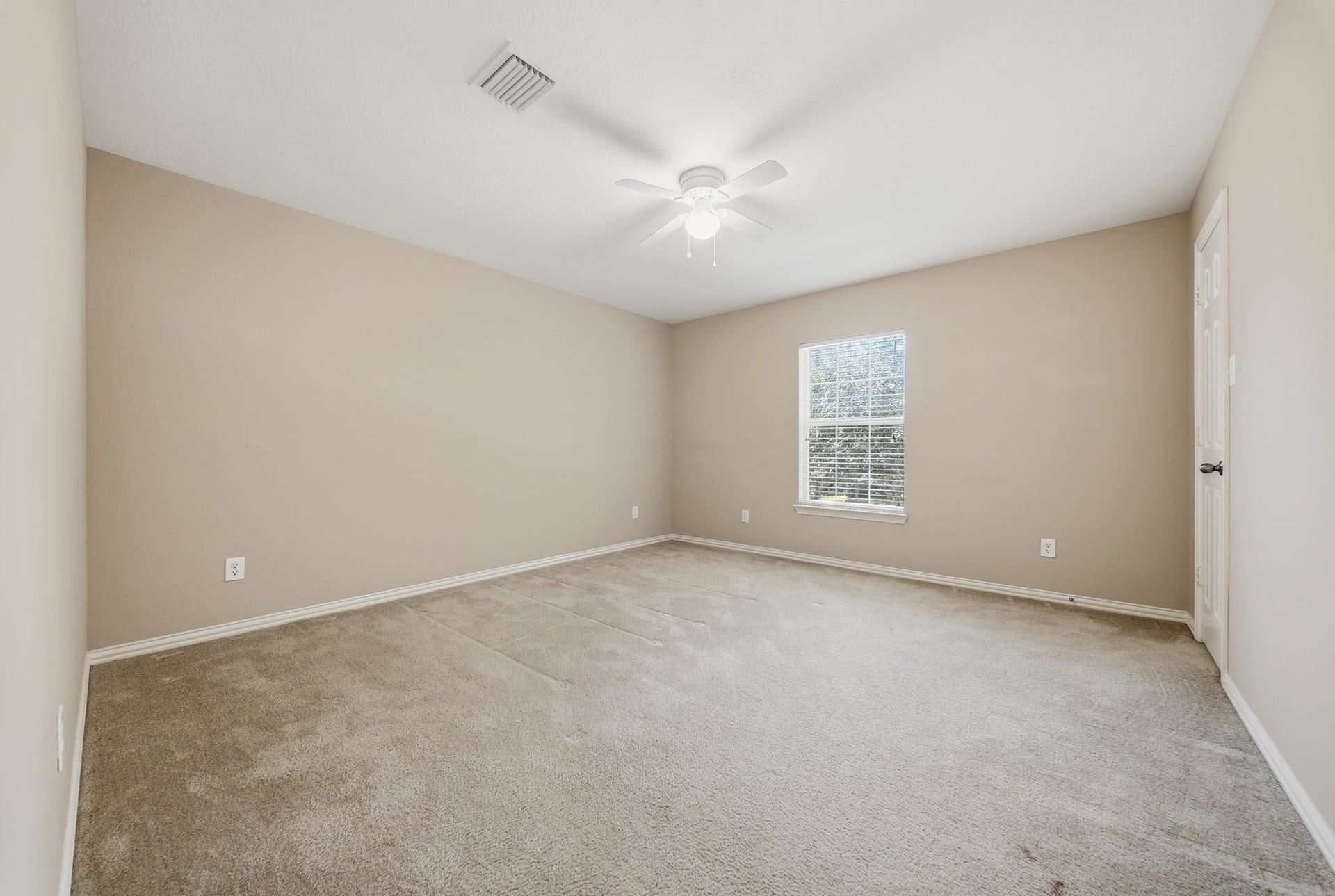 Upstairs Bedroom 4 features a front-facing window that welcomes natural light, offering a comfortable space for a bedroom, guest retreat, or home office.