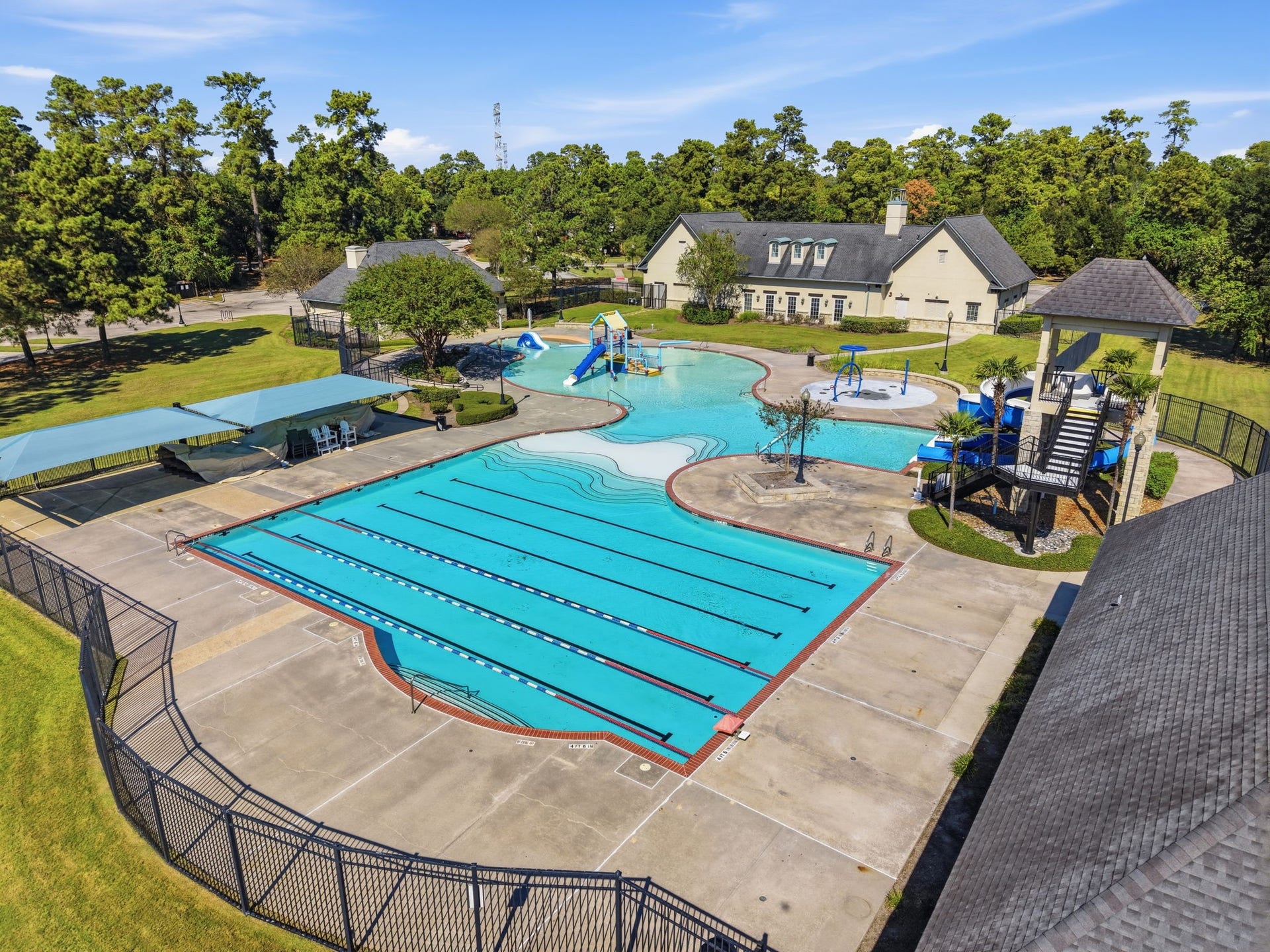 Enjoy Fall Creeks community pool with lap lanes, water slides, a splash area, and shaded seating for relaxing between swims.