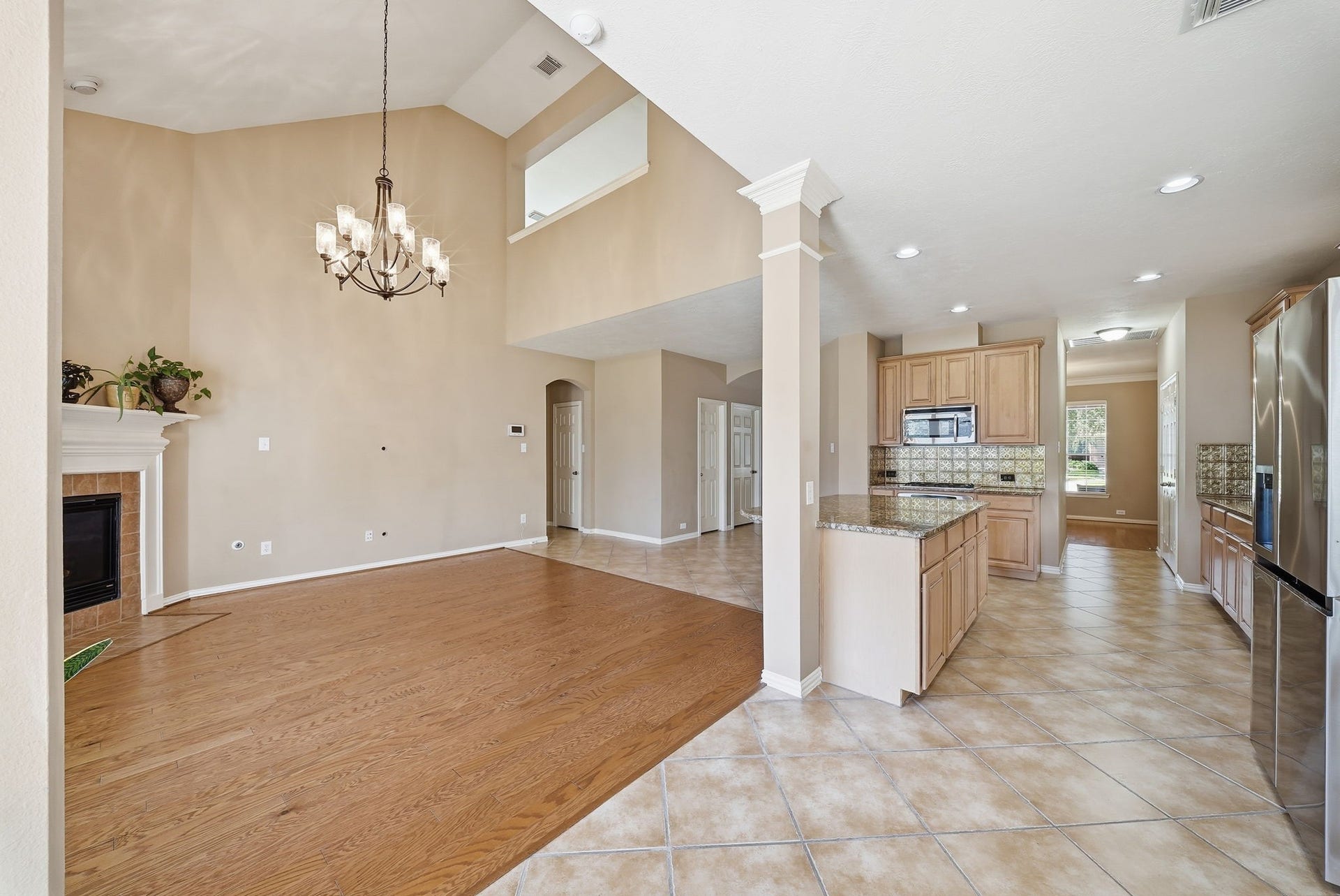 Dramatic two-story ceilings and an upstairs game room overlook give the living area a spacious, connected feelideal for gathering and entertaining.