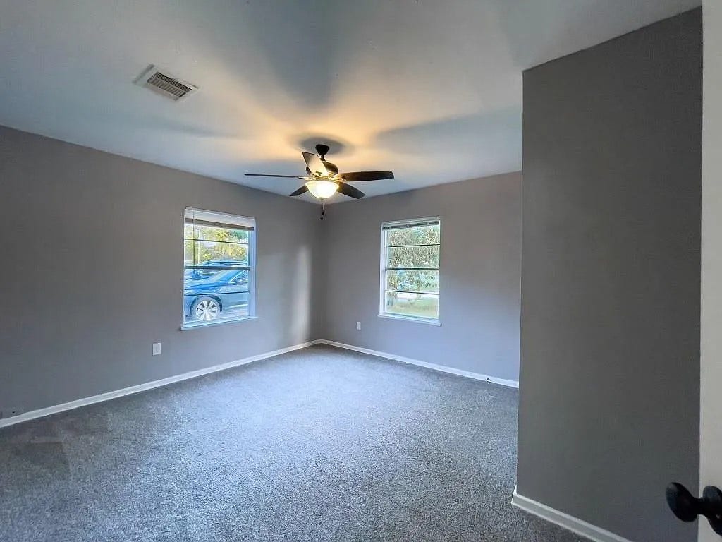 Bedroom with Ceiling Fan and Neutral Paint