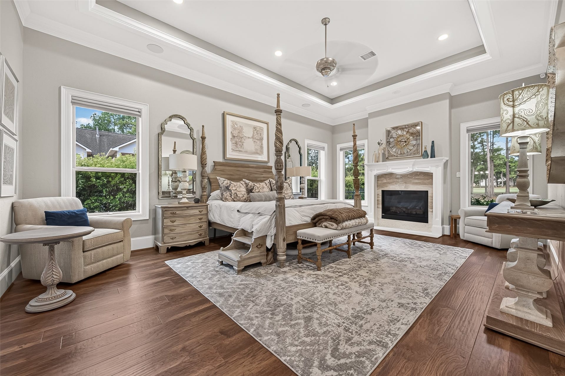 28723 Post Oak Run, Magnolia, TX 77355 Primary suite with a tray ceiling, wood floors and it's own fireplace.
