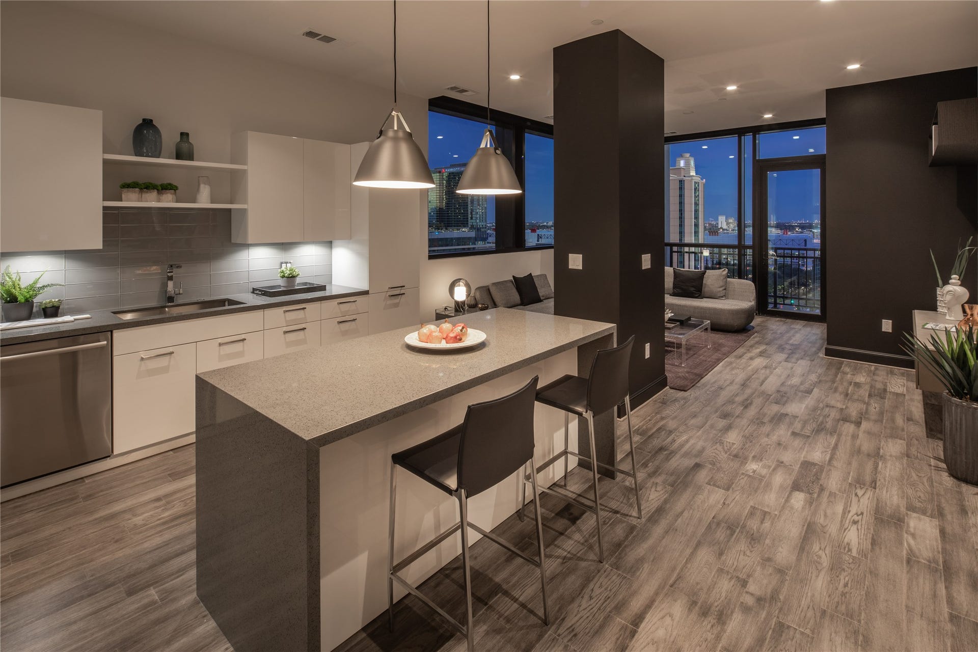 [Kitchen/Living VIRTUALLY STAGED] Well appointed open concept kitchen, built for functionality and entertainment, boasting large waterfall island with seating space