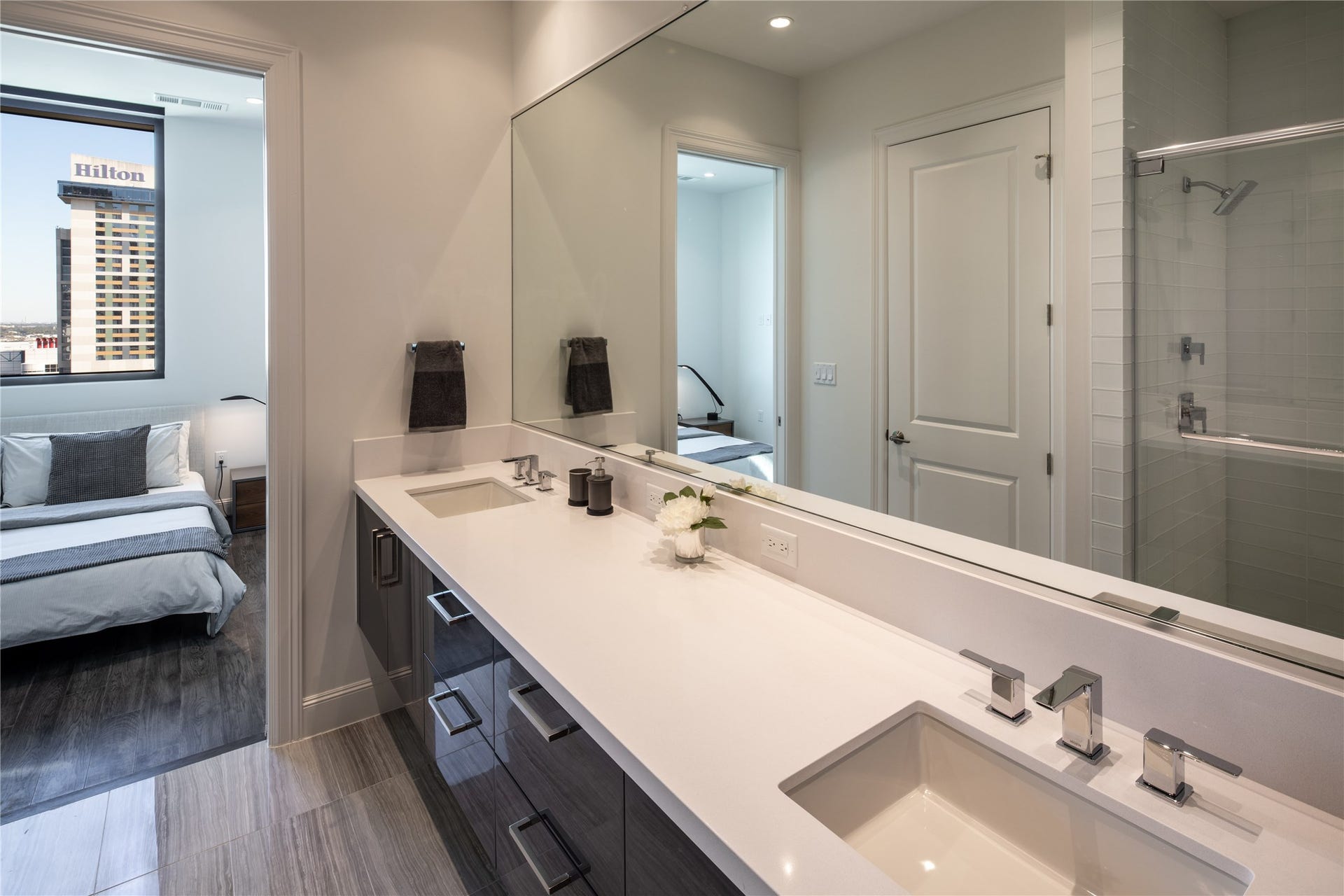 [Primary Bath & Bedroom] Alternate view, mirrored wall and ample counter space