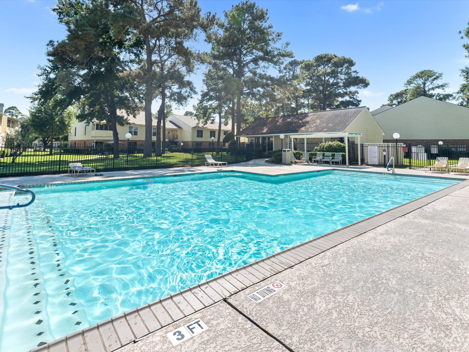 Another view of the sparkling community pool and surrounding lounge area.