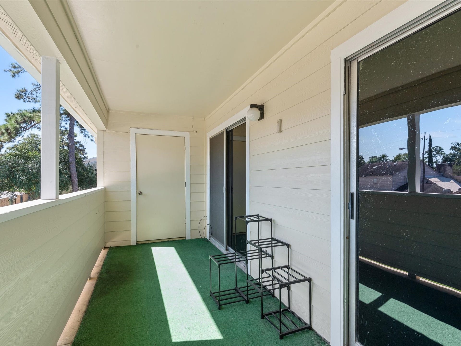 Private covered balcony offering a relaxing outdoor space.