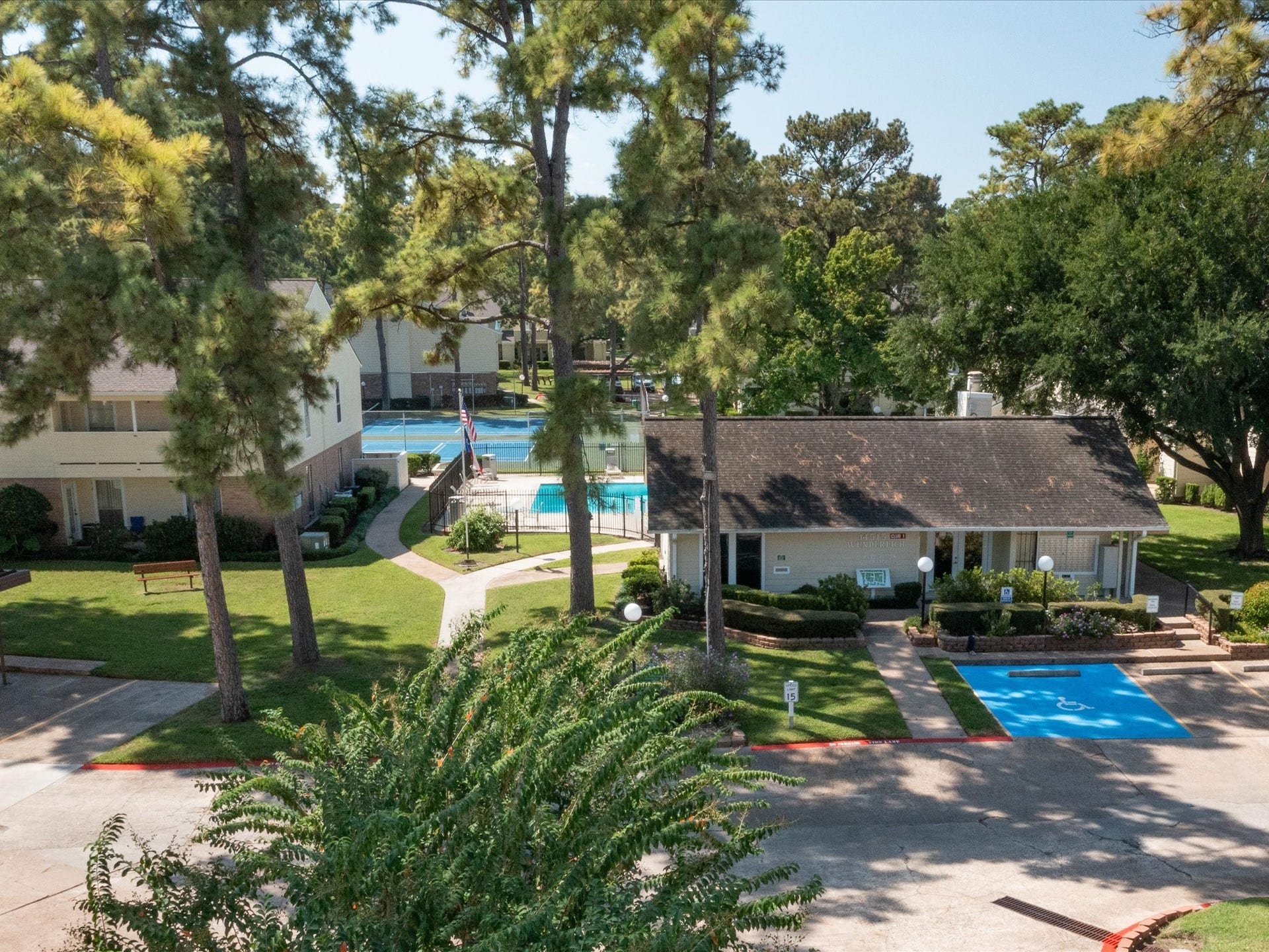 Beautifully landscaped community grounds with walking paths and views of the pool area.