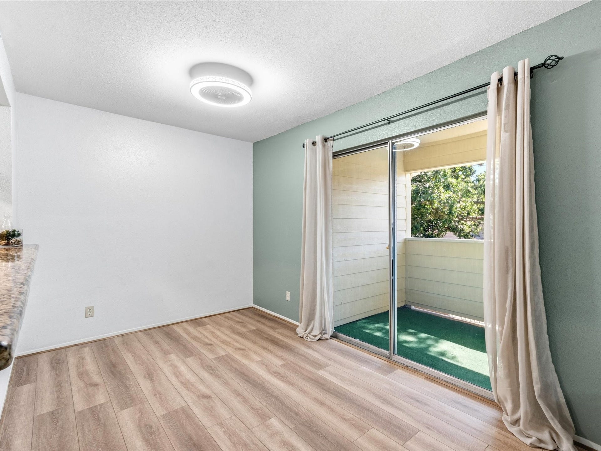 Dining space with sliding glass doors providing access to the outdoor patio.