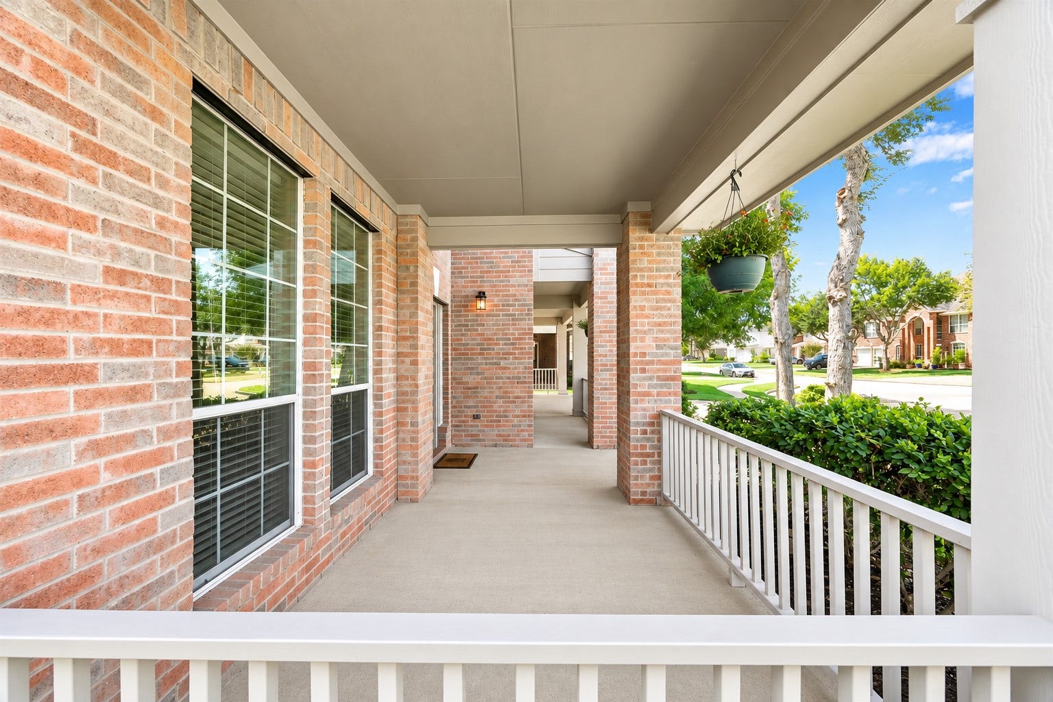 8126 BUFFALO SPRINGS COURT, Sugar Land, TX 77479 EXPANSIVE COVERED FRONT PORCH WITH BRICK COLUMNS AND PLENTY OF SPACE TO CREATE A WELCOMING OUTDOOR SITTING AREA.