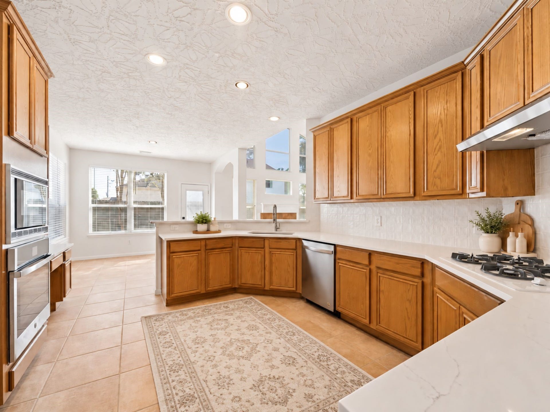 8126 BUFFALO SPRINGS COURT, Sugar Land, TX 77479 ADDITIONAL KITCHEN STORAGE INCLUDES BUILT-IN APPLIANCES, TALL CABINETRY, AND A CONVENIENT DESK OR PLANNING AREA.