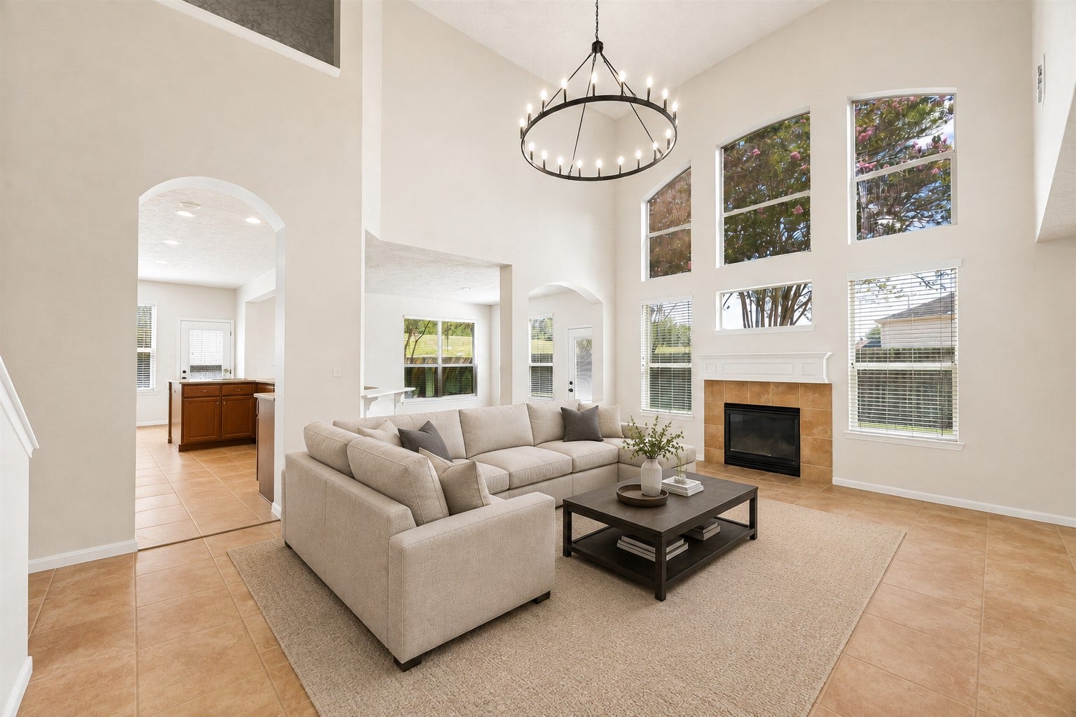 8126 BUFFALO SPRINGS COURT, Sugar Land, TX 77479 SOARING TWO-STORY LIVING AREA WITH OPEN SIGHTLINES TO THE KITCHEN AND BREAKFAST SPACE. A LARGE STATEMENT CHANDELIER AND ABUNDANT NATURAL LIGHT EMPHASIZE THE IMPRESSIVE SCALE.