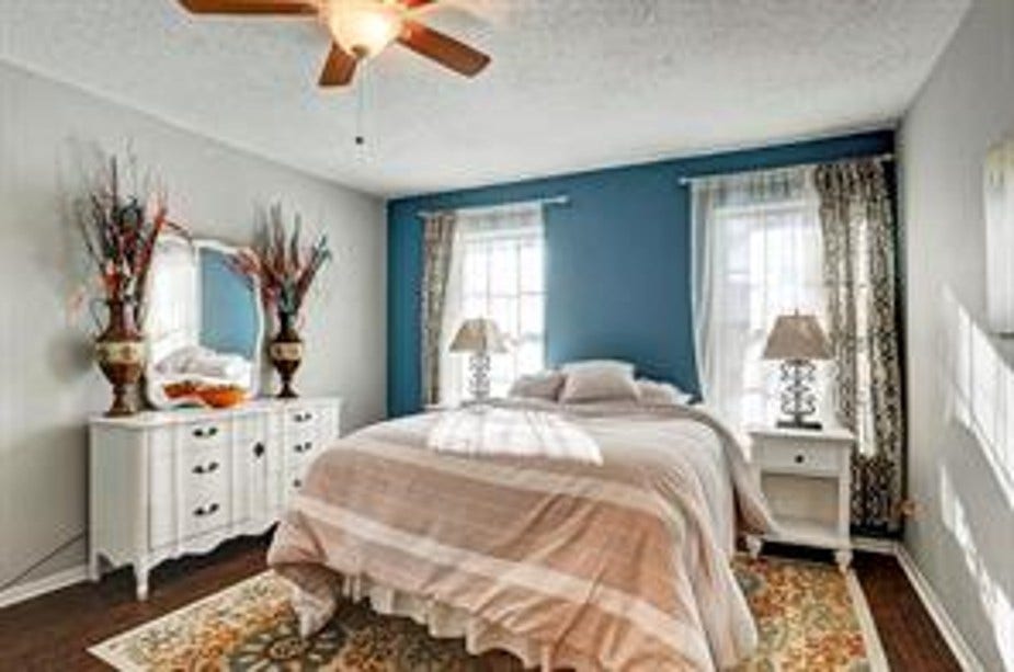 351 N Post Oak Lane, #715, Houston, TX 77024 Primary bedroom with same warm wood floors throughout the home. Easily houses a king size bed with dresser and side tables.