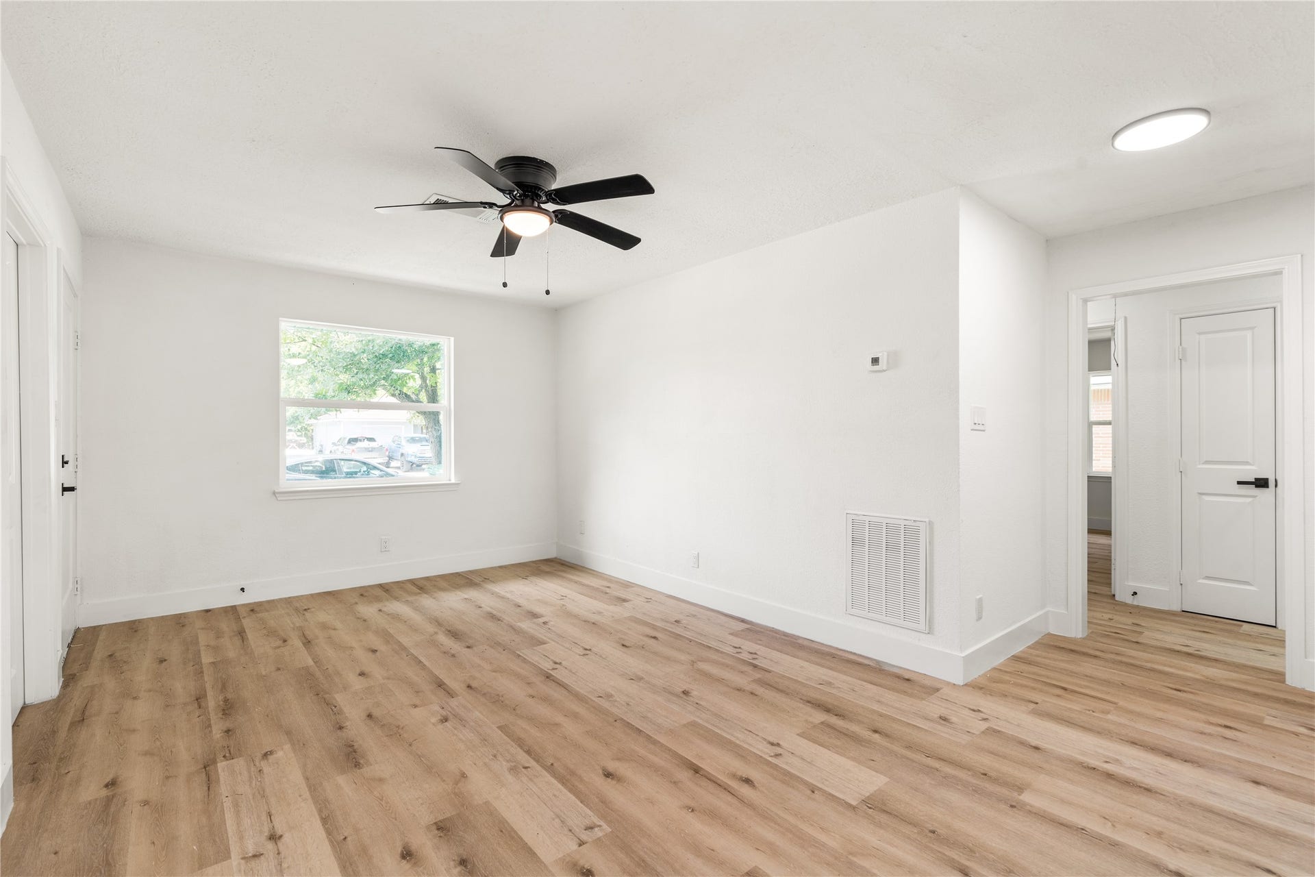 3048 Briarwick Lane, Houston, TX 77093 Another angle of living area featuring the crisp white walls, and a modern ceiling fan.