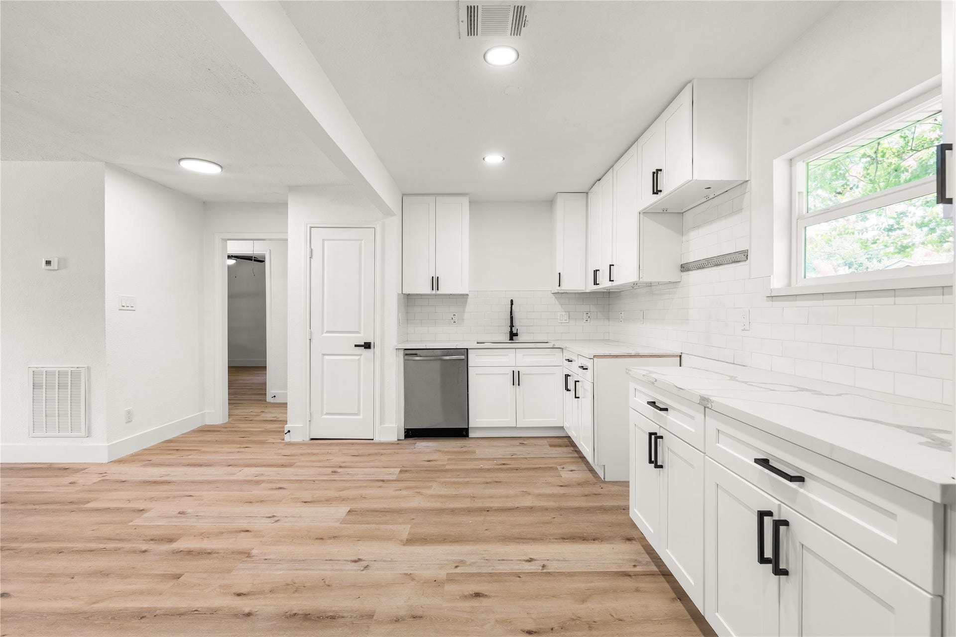 3048 Briarwick Lane, Houston, TX 77093 Modern kitchen layout highlighting expansive prep counter space, and a classic subway tile backsplash.