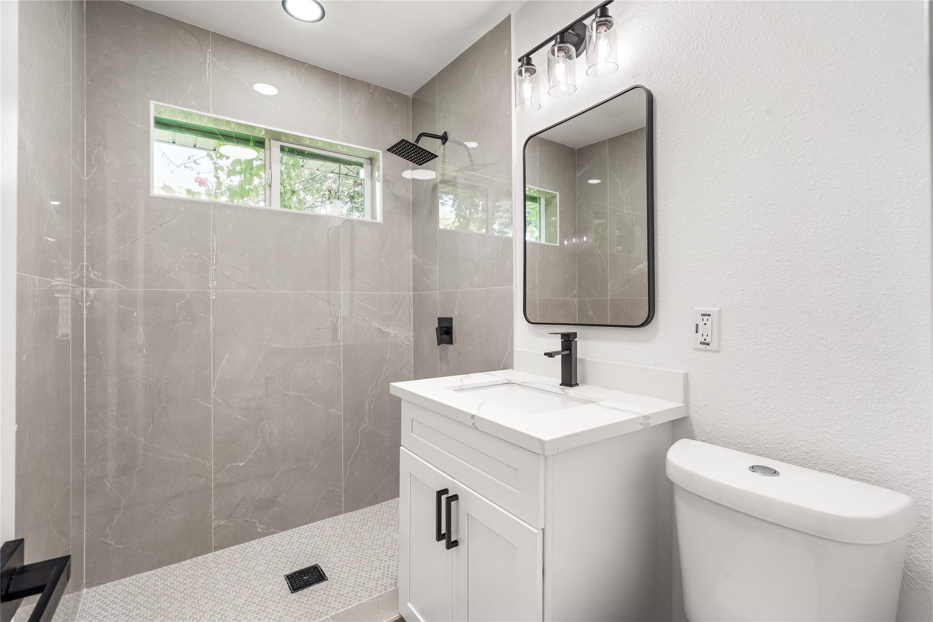 3048 Briarwick Lane, Houston, TX 77093 Sophisticated bathroom showcasing timeless tilework, sleek modern fixtures, and a bright, spa-inspired ambiance.