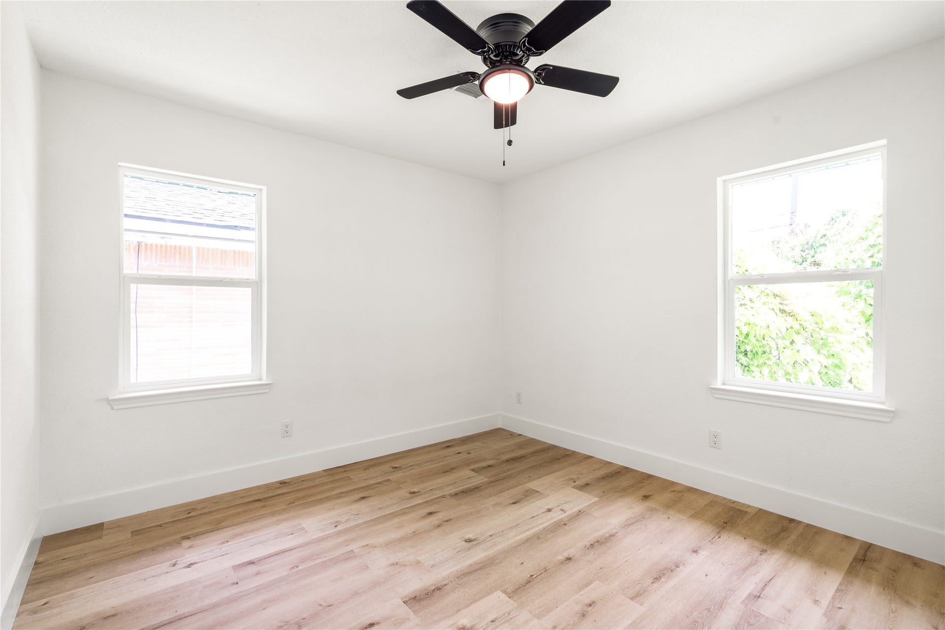 3048 Briarwick Lane, Houston, TX 77093 Sunlit bedroom with beautiful light wood flooring, fresh neutral finishes, and great natural light.
