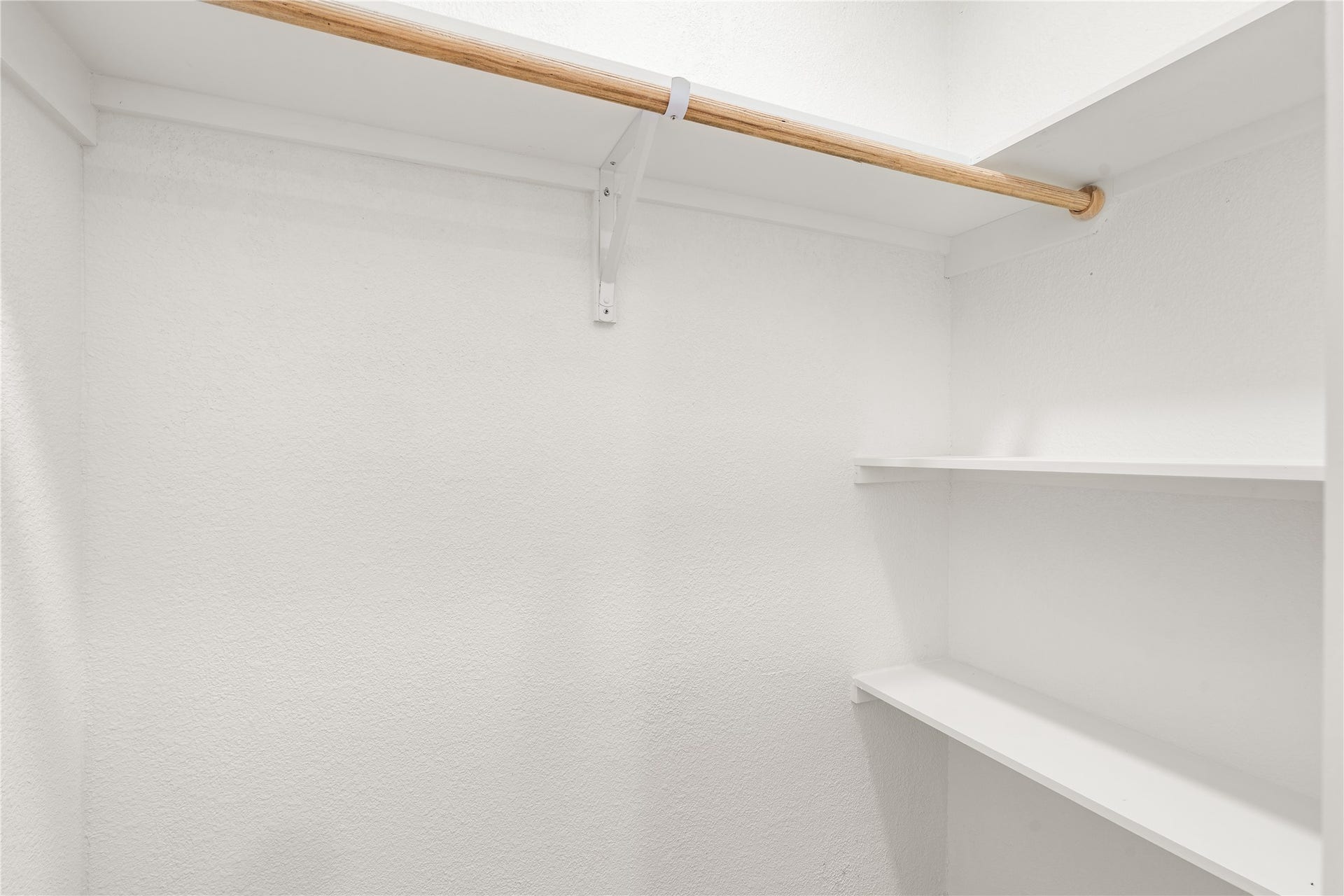 3048 Briarwick Lane, Houston, TX 77093 Thoughtfully designed walk-in primary closet with generous storage, open shelving, and ample hanging space for effortless organization.