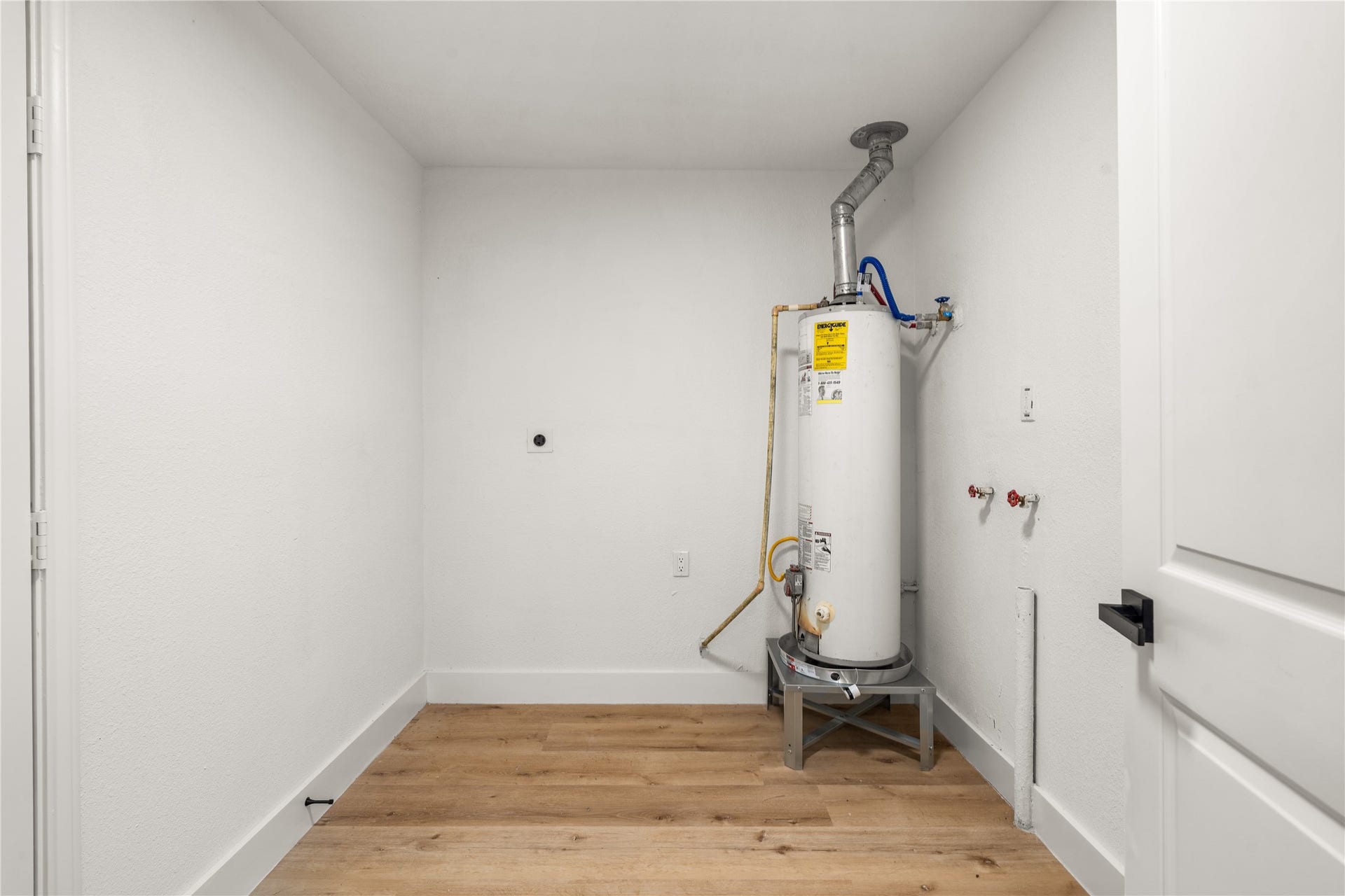 3048 Briarwick Lane, Houston, TX 77093 Dedicated laundry room complete with convenient washer and dryer connections, sleek white trim, and modern door hardware.